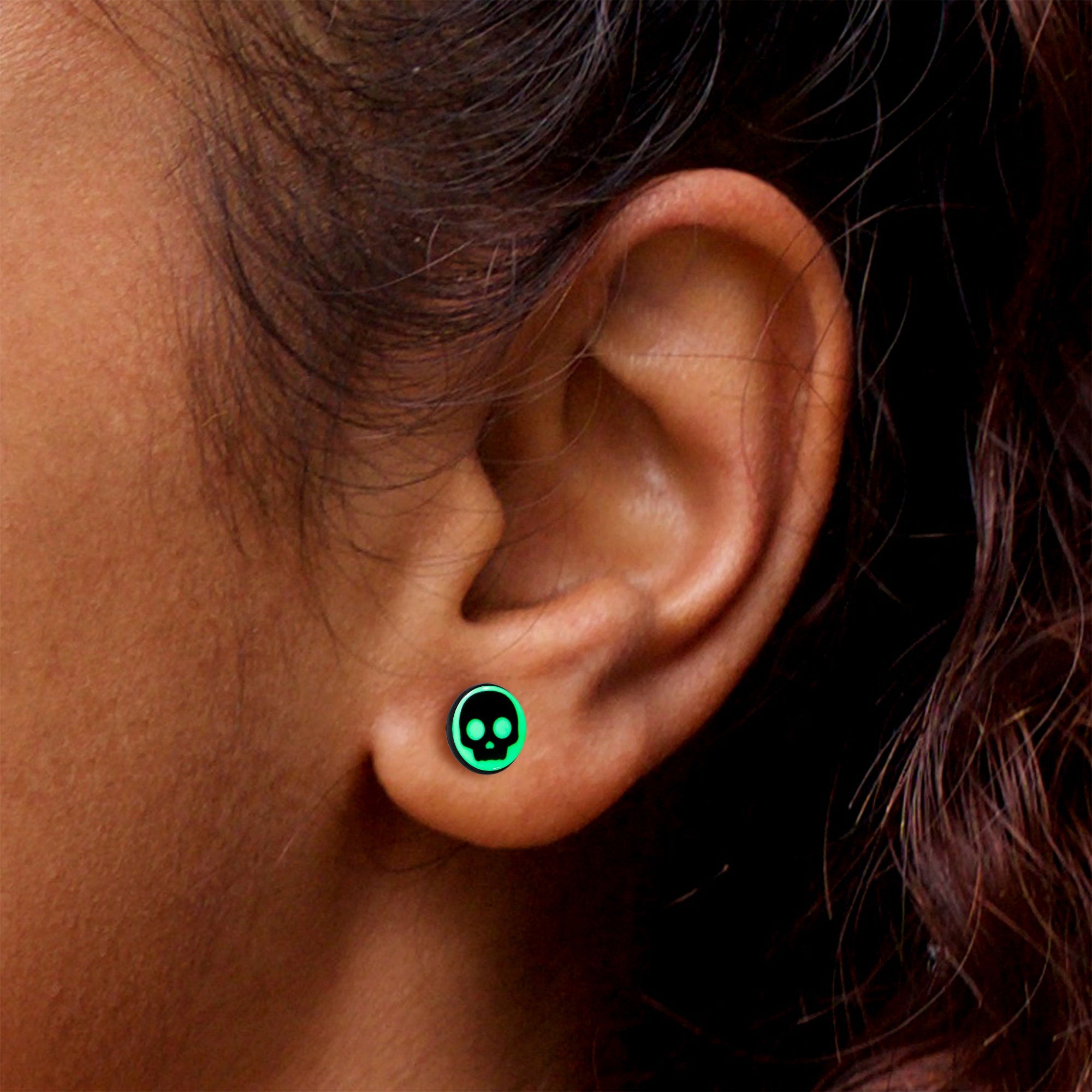 BodyCandy Simple Skull Glow in the Dark Stud Earrings by Onyx O — in-use photo