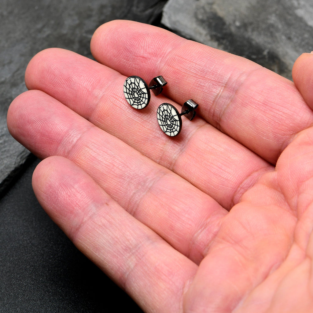 BodyCandy Black Anodized Steel Heart Spider Web Glow in the Dark Stud Earrings by Onyx O — lifestyle context