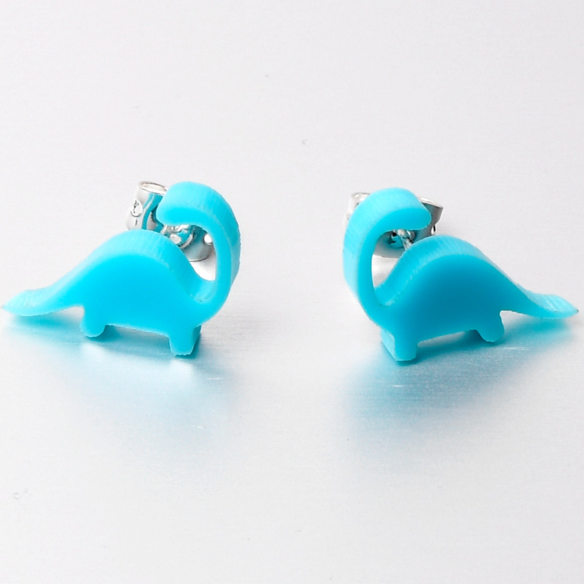BodyCandy Blue Acrylic Brontosaurus Dinosaur Stud Earrings — lifestyle context