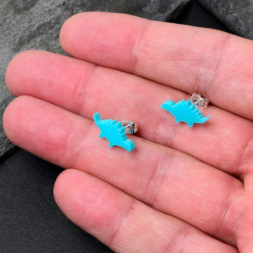 BodyCandy Blue Acrylic Stegosaurus Dinosaur Stud Earrings — detail close-up