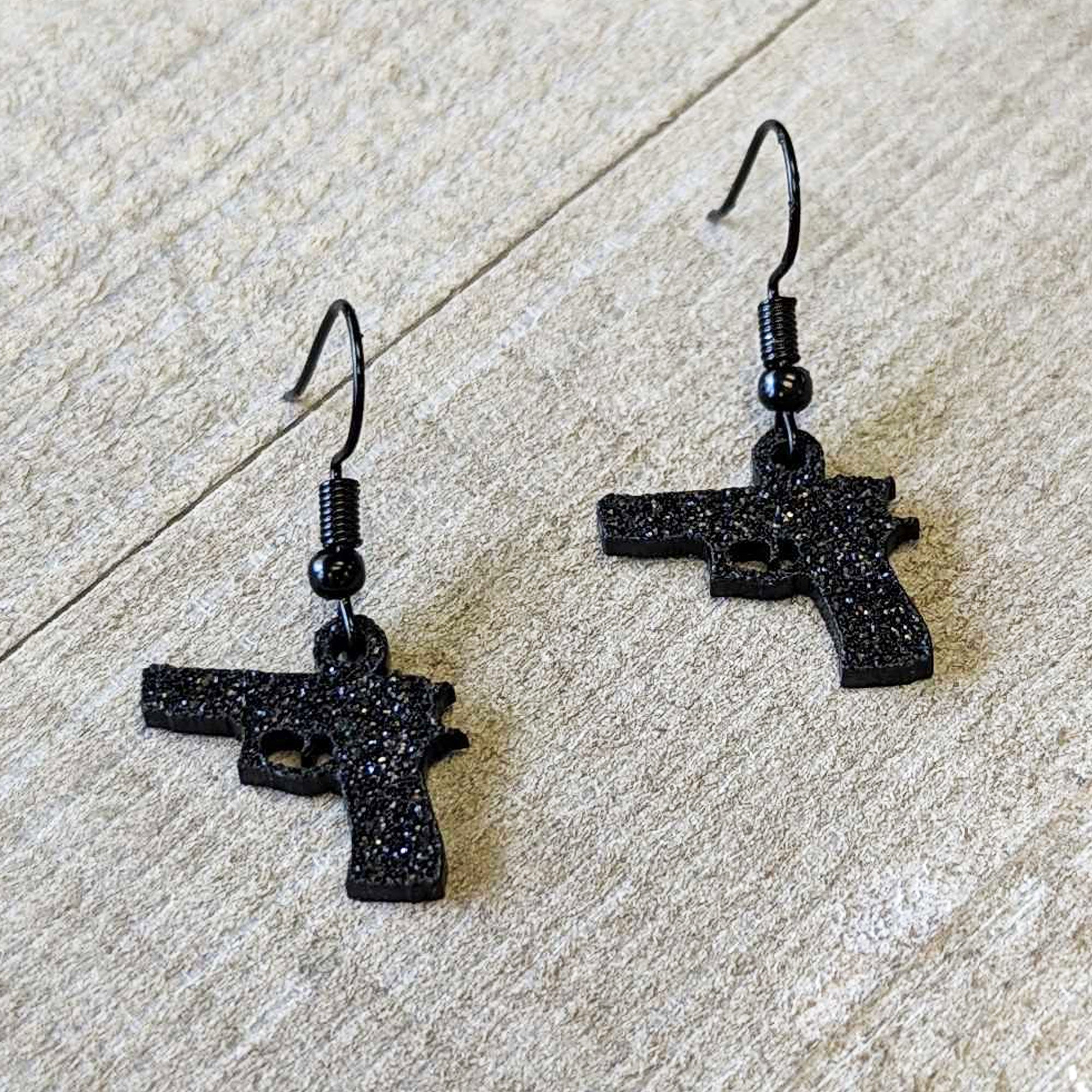 BodyCandy Black Glitter Gun Fishhook Dangle Earrings — lifestyle context