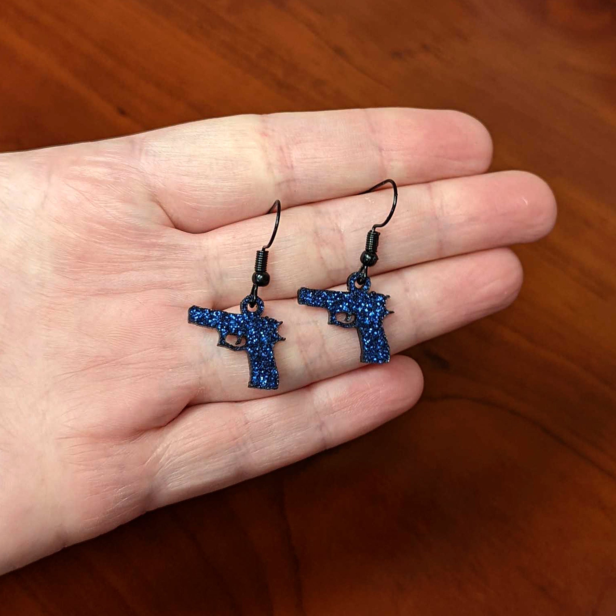 BodyCandy Blue Glitter Gun Fishhook Dangle Earrings — lifestyle context