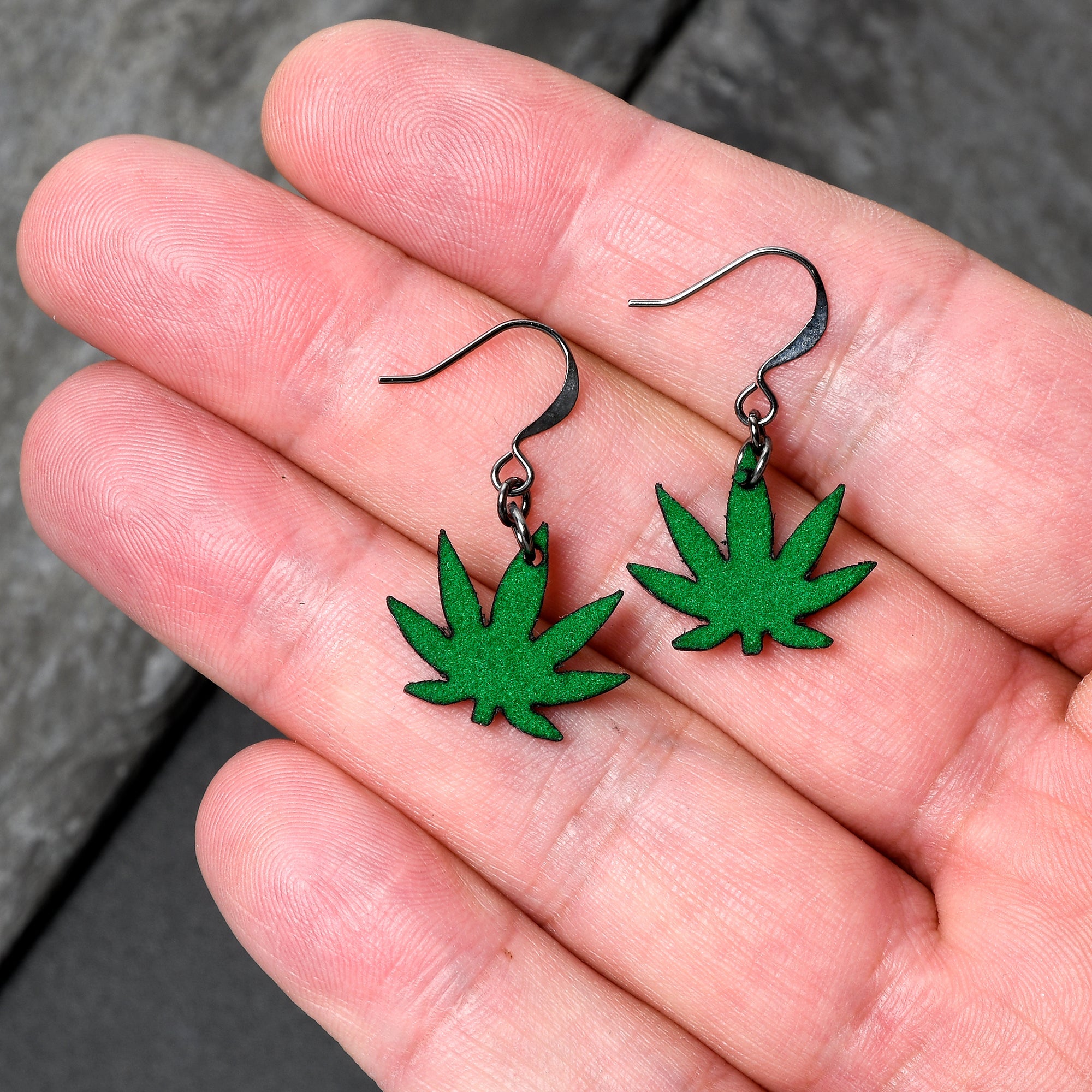 BodyCandy Green Marijuana Pot Leaf Dangle Earrings — detail close-up