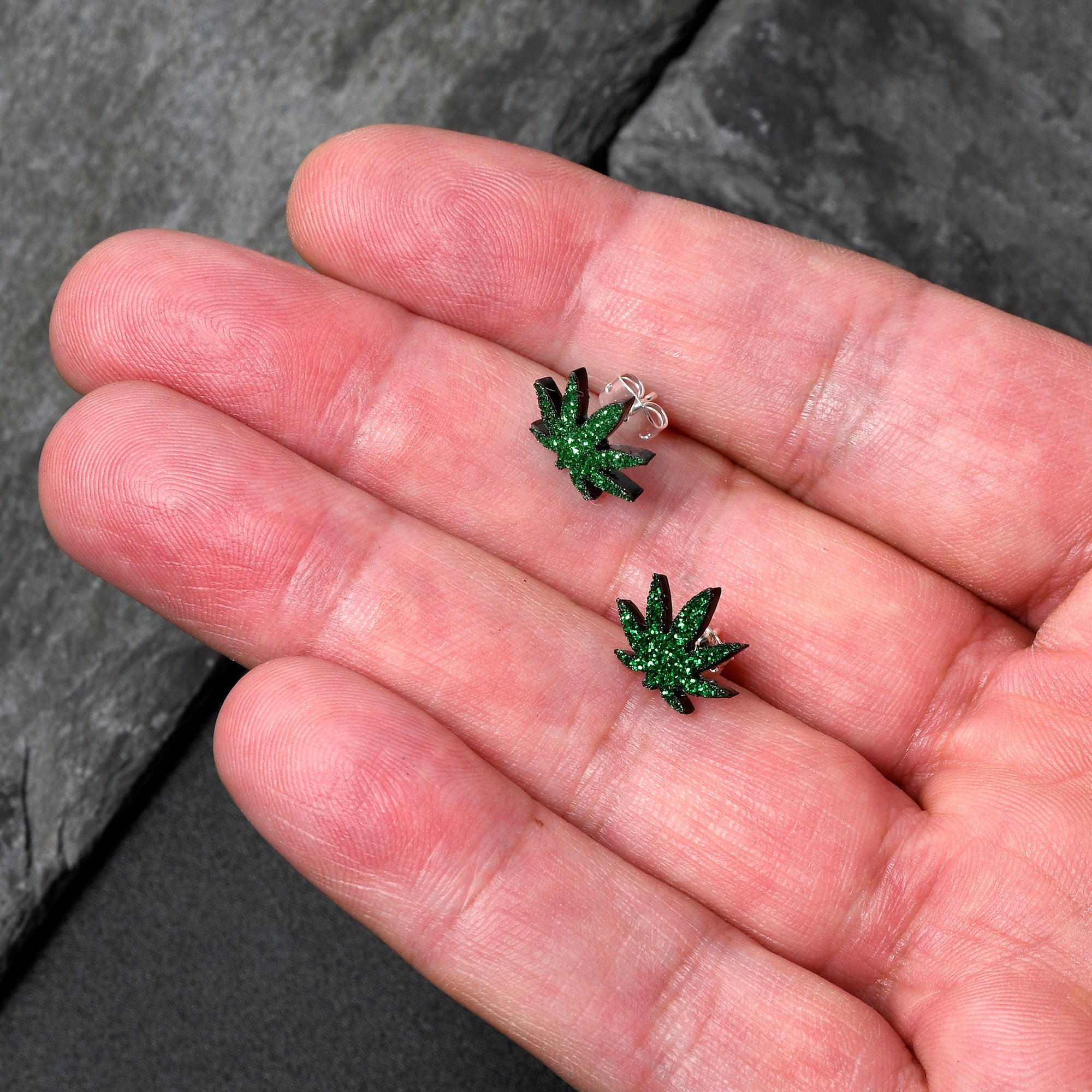 BodyCandy Green Glitter Marijuana Pot Leaf Stud Earrings — detail close-up
