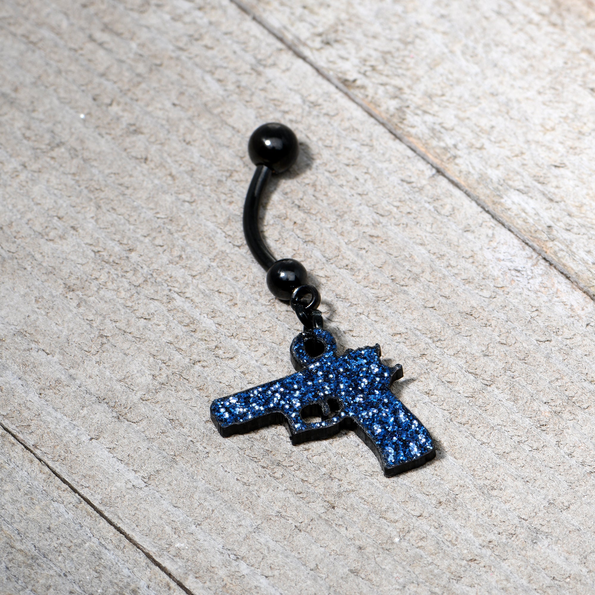 BodyCandy Blue Glitter Gun Dangle Belly Ring — side view