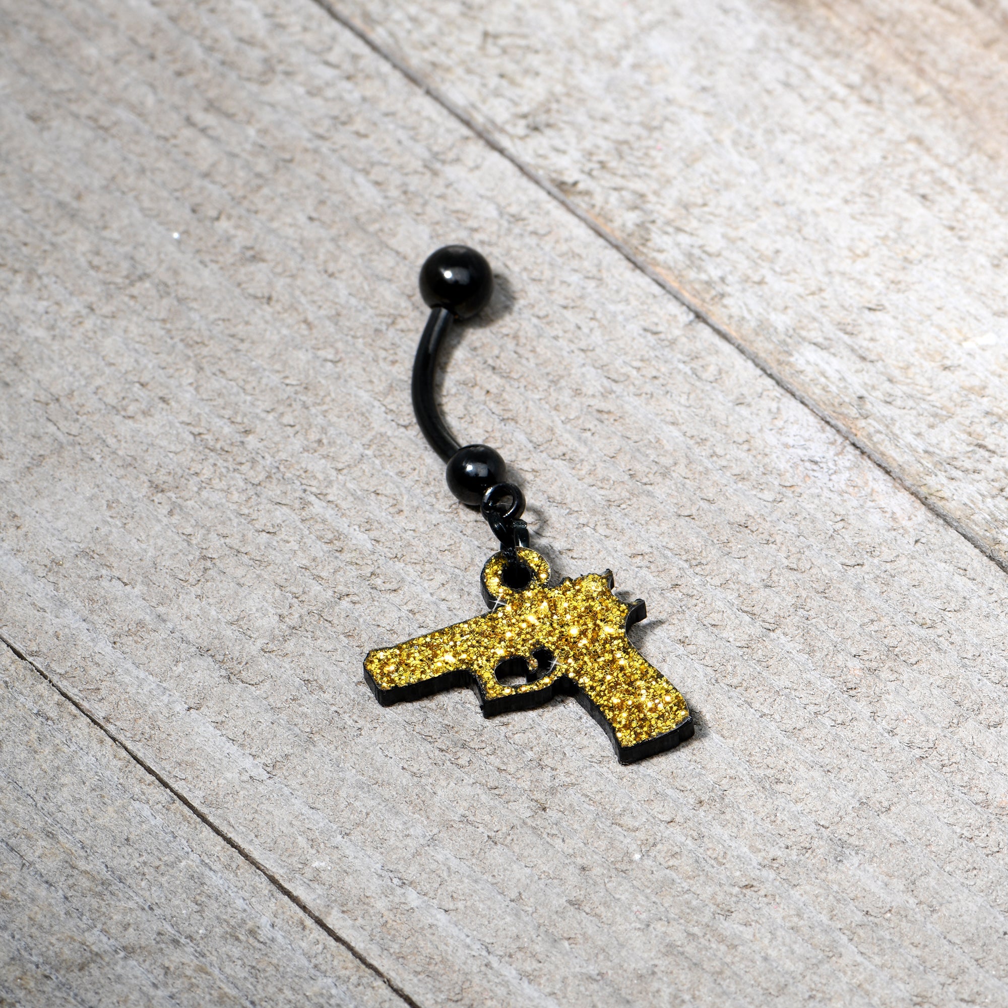 BodyCandy Yellow Glitter Gun Dangle Belly Ring — side view