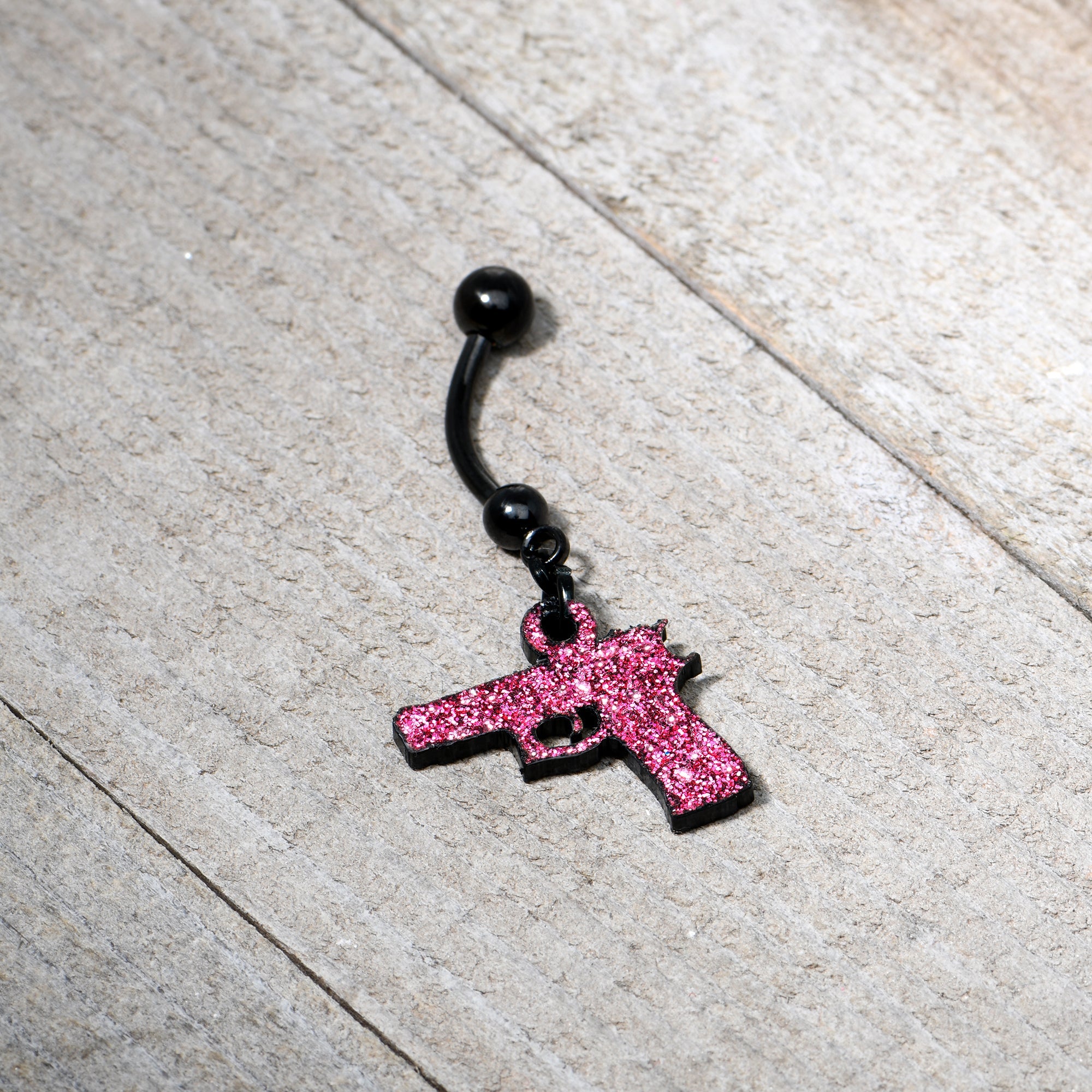 BodyCandy Pink Glitter Gun Dangle Belly Ring — side view