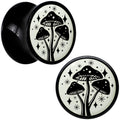 BodyCandy Glow in the Dark Mystic Mushroom Black Acrylic Saddle Plug Set by Onyx O — flat-lay composition