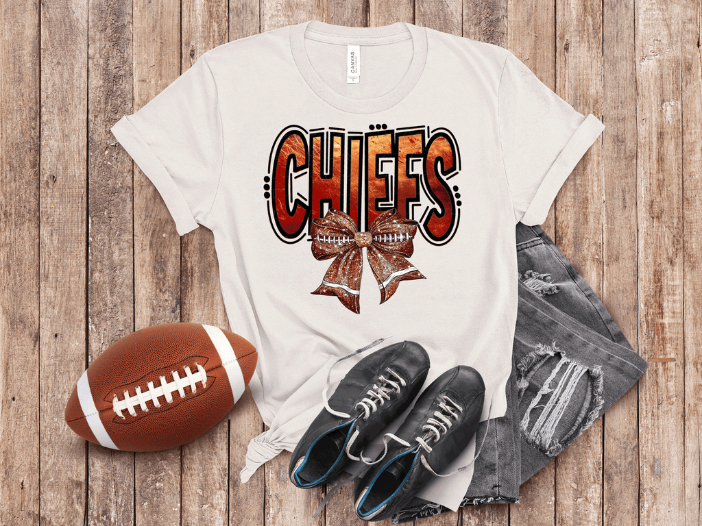 A Blessed Texas Mess Boutique Kansas City Football Metallic shirt, faux glitter football Coquette bow Shirt,… — main product shot