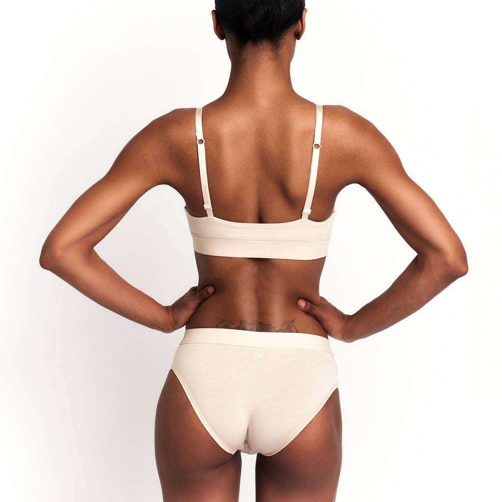 Net Positive Mid-Rise Brief — Net Positive branding close-up
