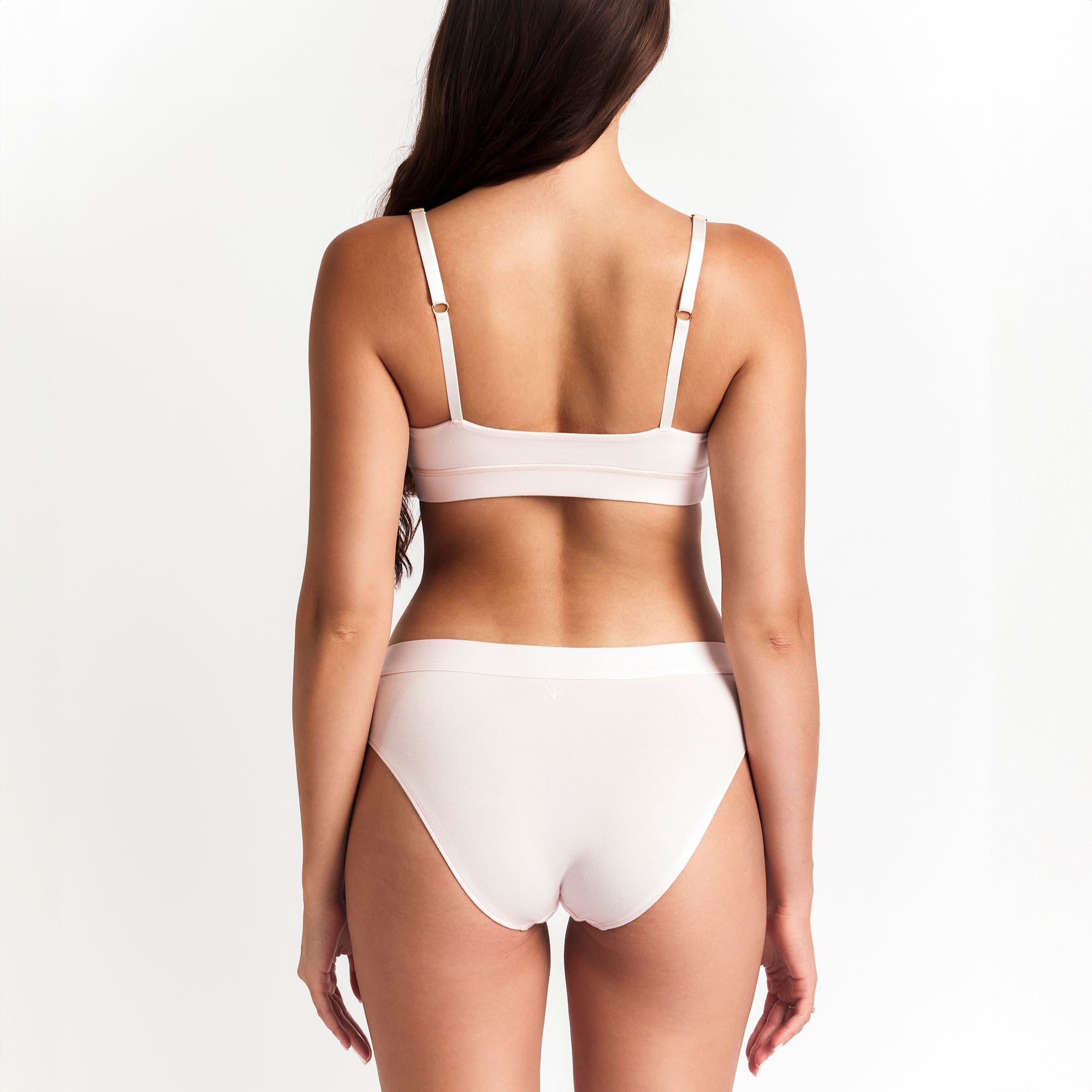 Net Positive Mid-Rise Brief — Net Positive branding close-up