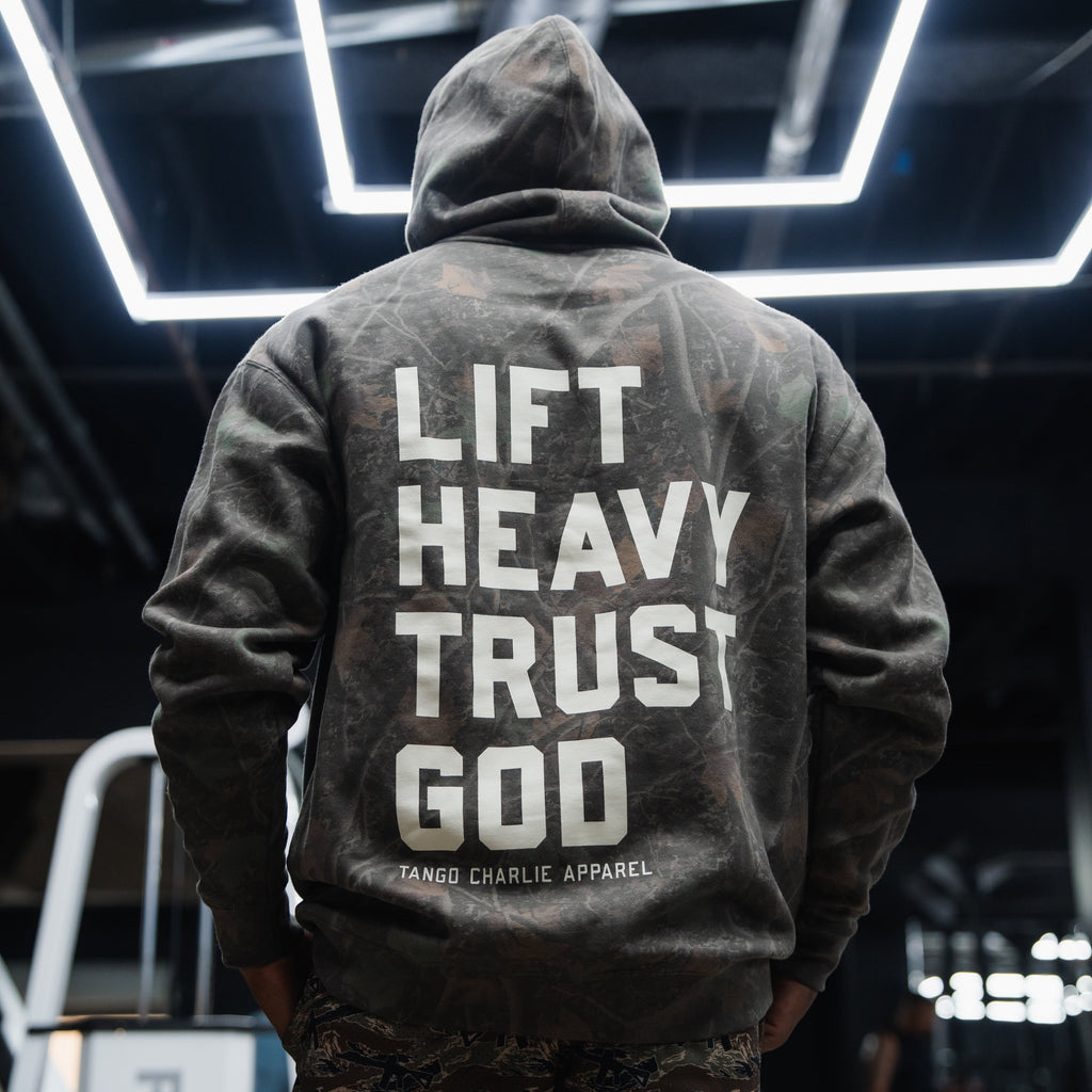 Lift Heavy. Trust God. - Premium Darkwood Camo Hoodie