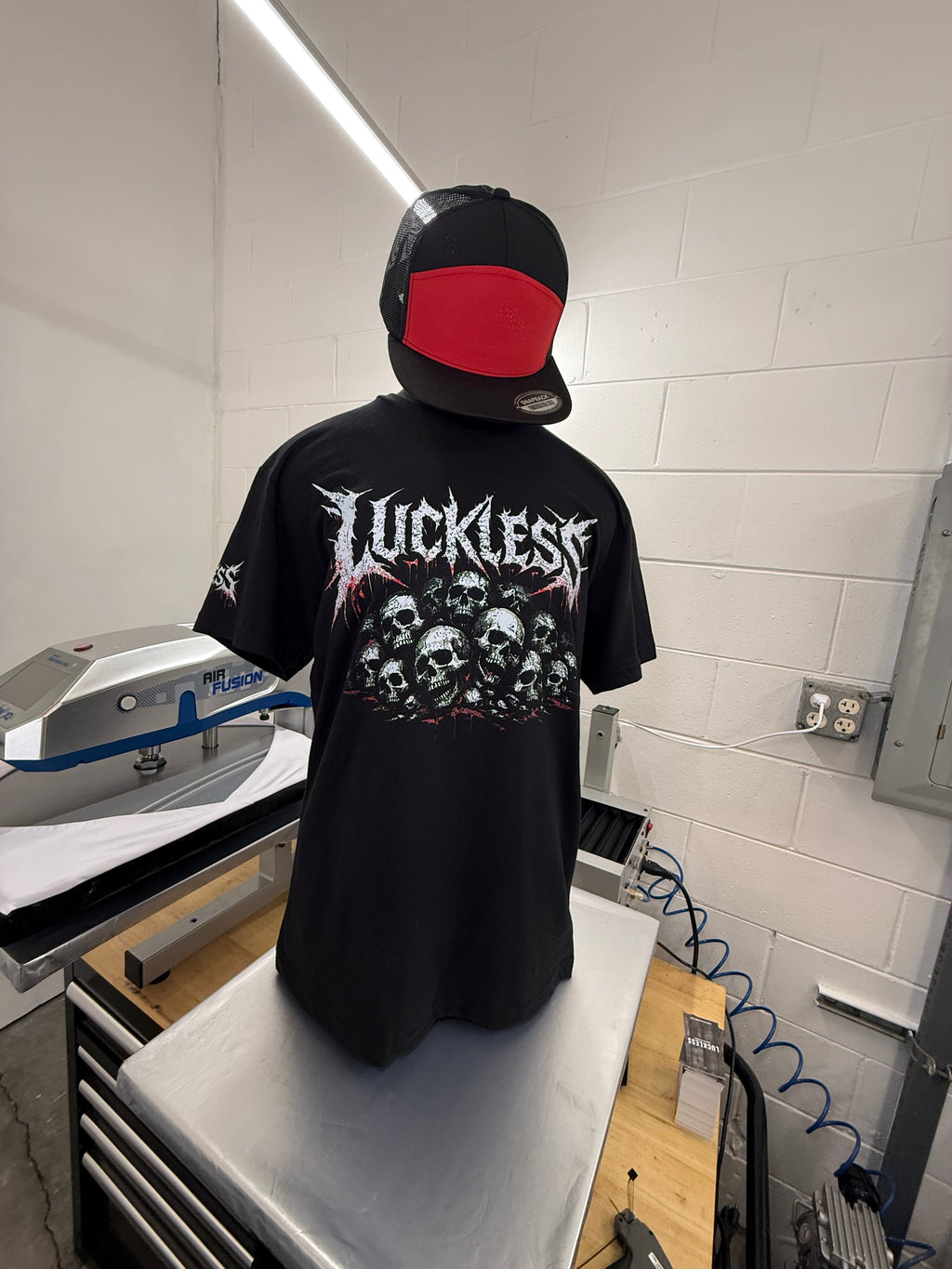Luckless Outfitters Pile of Skulls Tee — side view