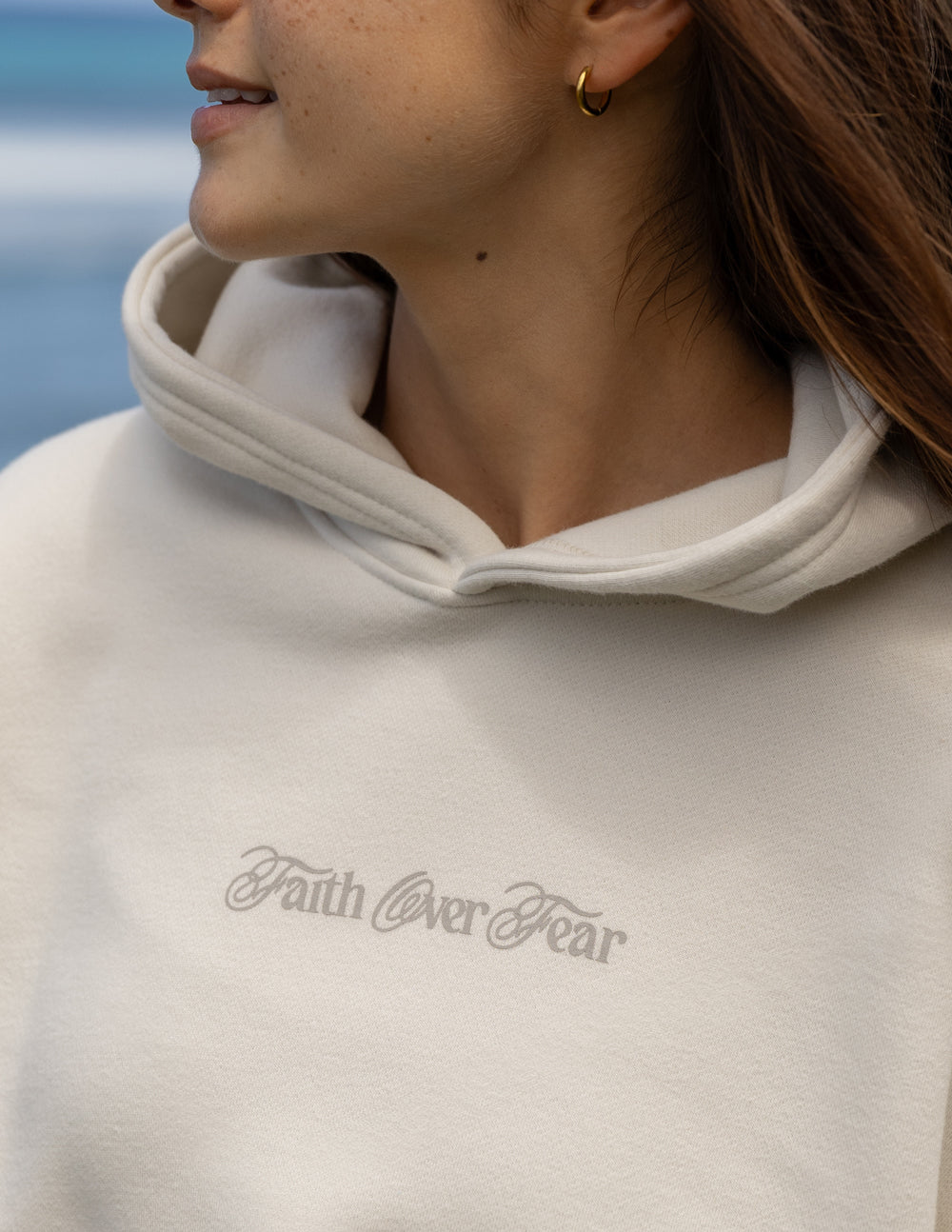 Elevated Faith Faith Over Fear Taupe Unisex Hoodie — Elevated Faith branding close-up