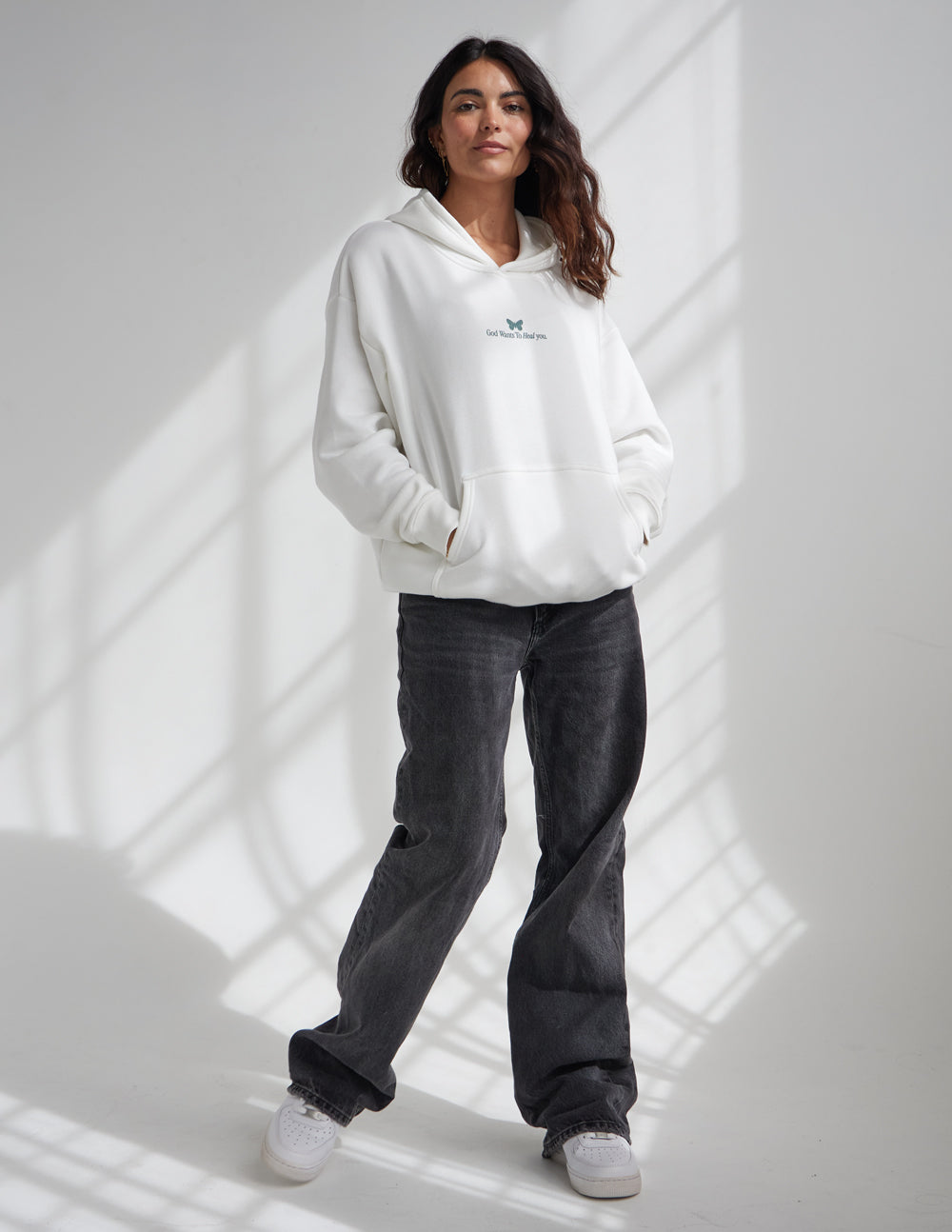 Elevated Faith God Heals Unisex Hoodie — Elevated Faith branding close-up