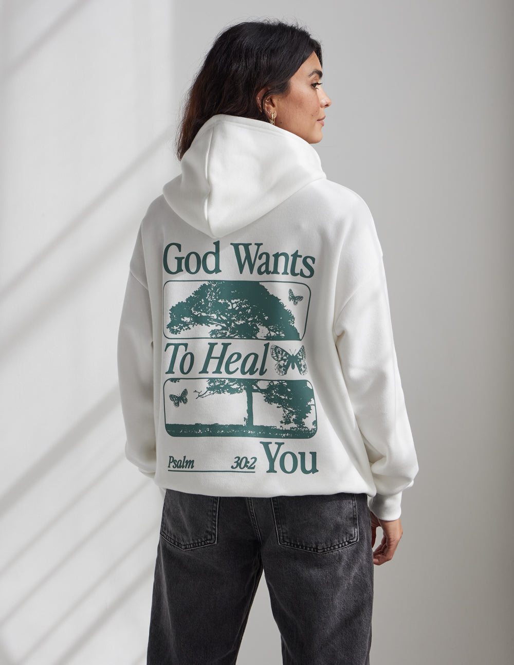 Elevated Faith God Heals Unisex Hoodie — lifestyle worn / used context