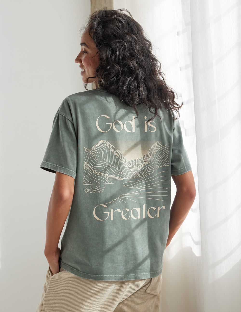 Elevated Faith God Is Greater Unisex Tee — lifestyle worn / used context