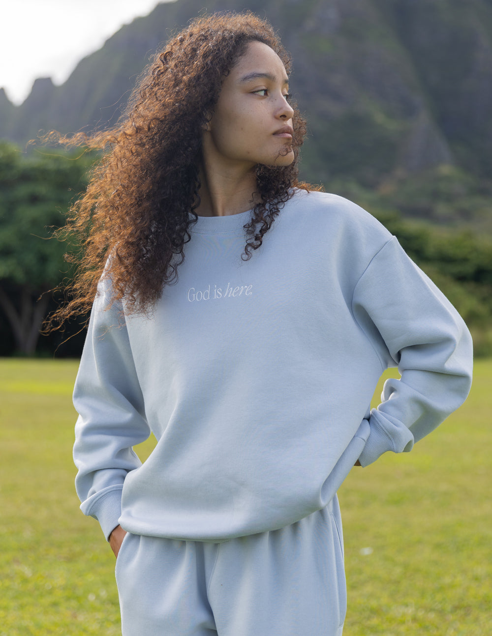 Elevated Faith God Is Here Unisex Crewneck — lifestyle worn / used context