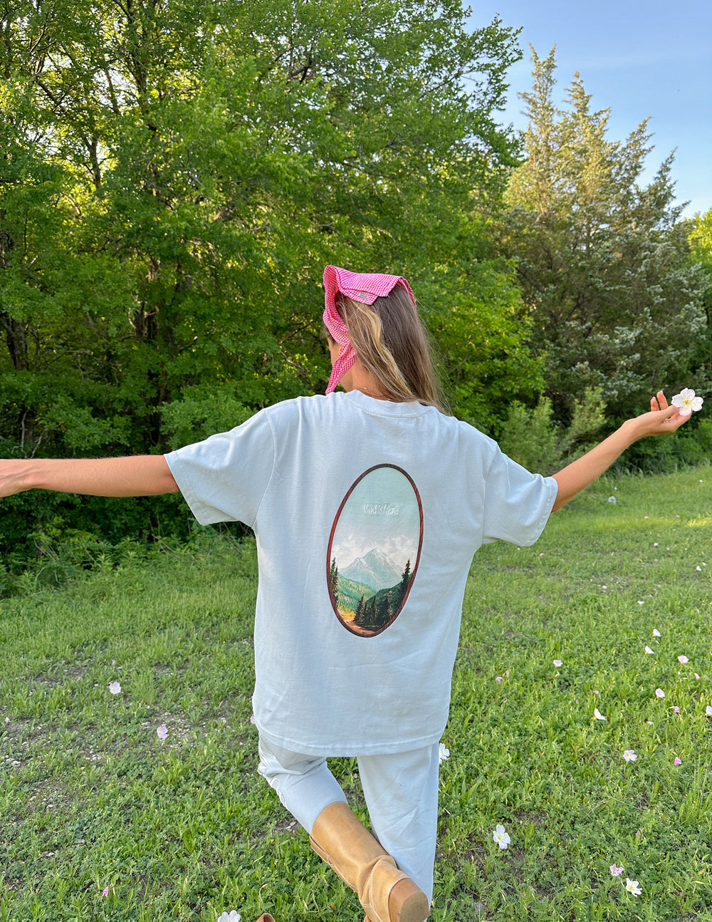 Elevated Faith God Is Here Unisex Tee — lifestyle worn / used context