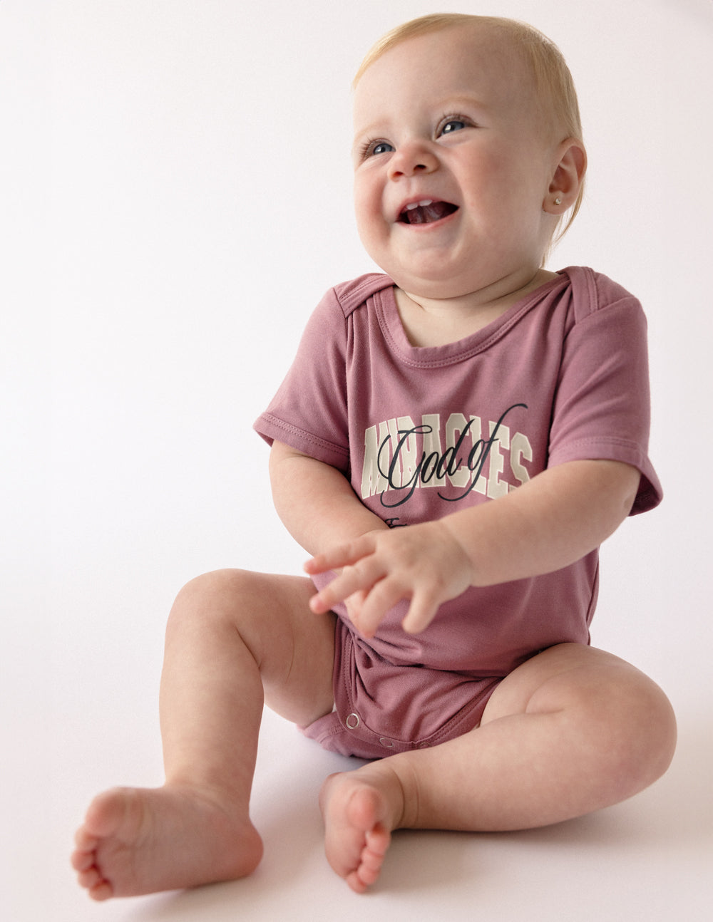 Elevated Faith God of Miracles Onesie — detail close-up