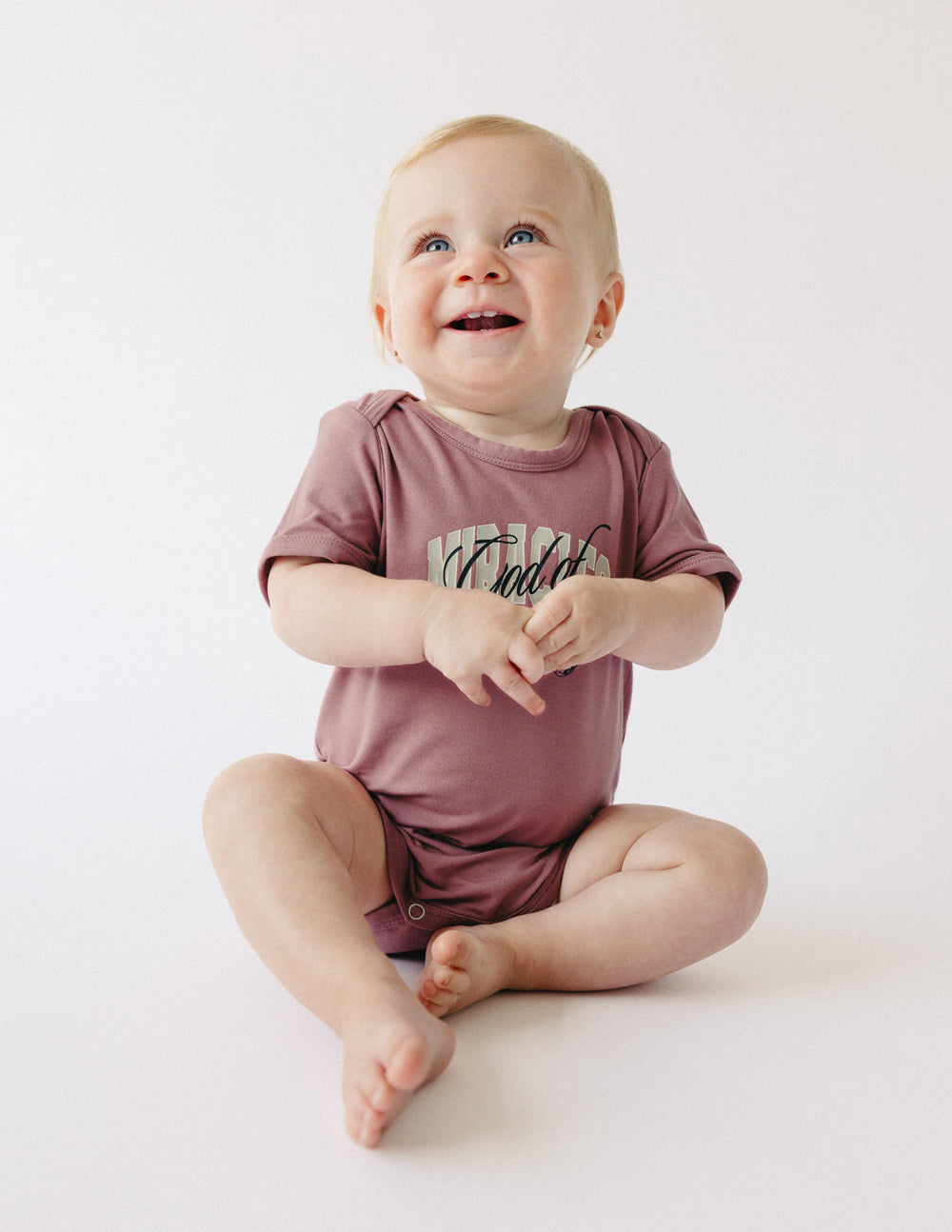 Elevated Faith God of Miracles Onesie — lifestyle context