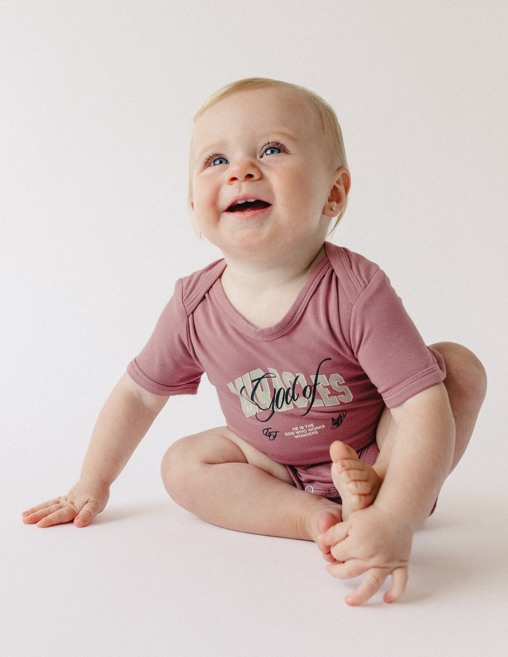 Elevated Faith God of Miracles Onesie — side view