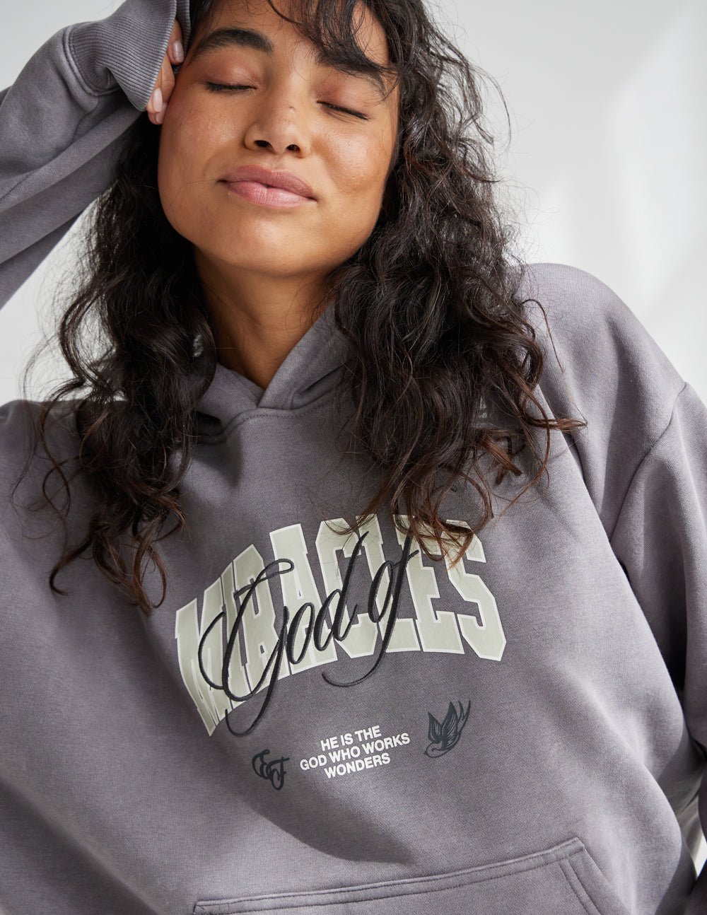 Elevated Faith God of Miracles Unisex Hoodie — Elevated Faith branding close-up