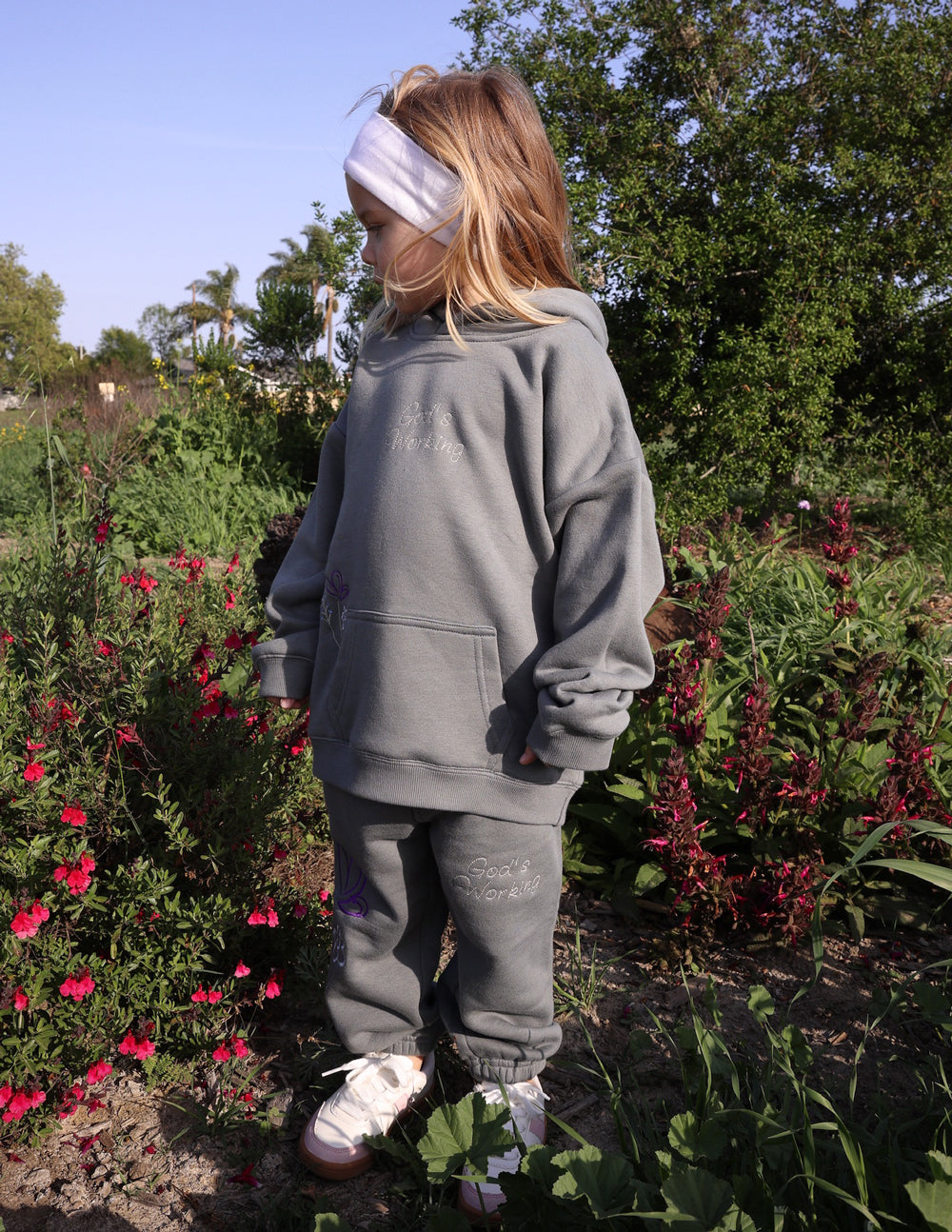Elevated Faith God's Still Working Kids Hoodie — packaging
