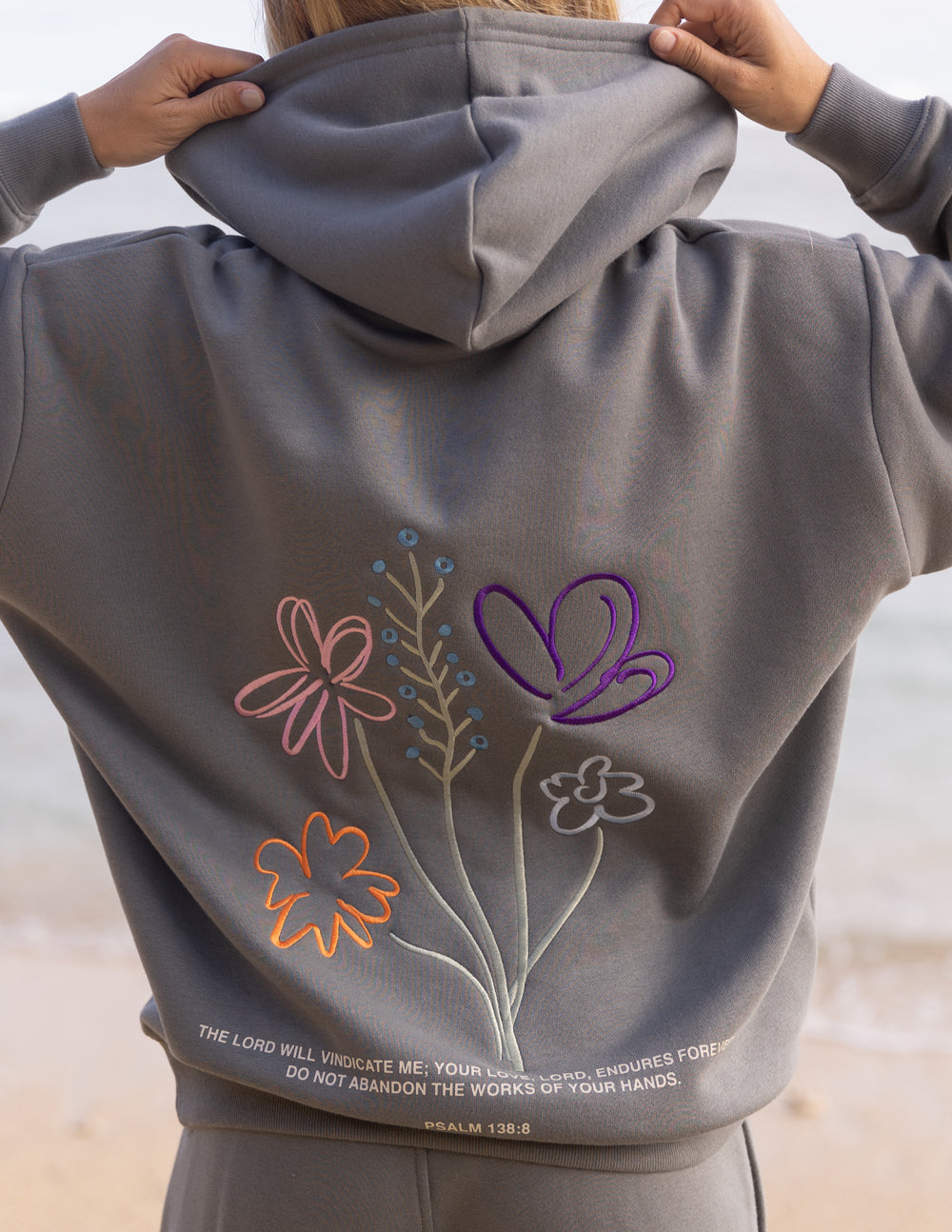 Elevated Faith God's Still Working Unisex Hoodie — lifestyle worn / used context