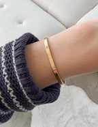 Elevated Faith Gold Highs and Lows Cuff Bracelet — Elevated Faith branding close-up