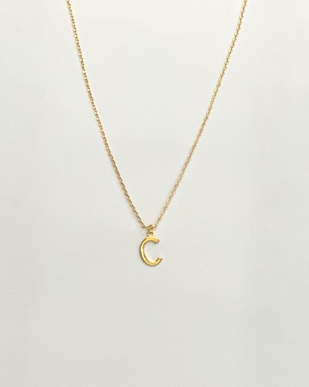 KADOU BOUTIQUE Letter Pendent Necklace — flat-lay composition
