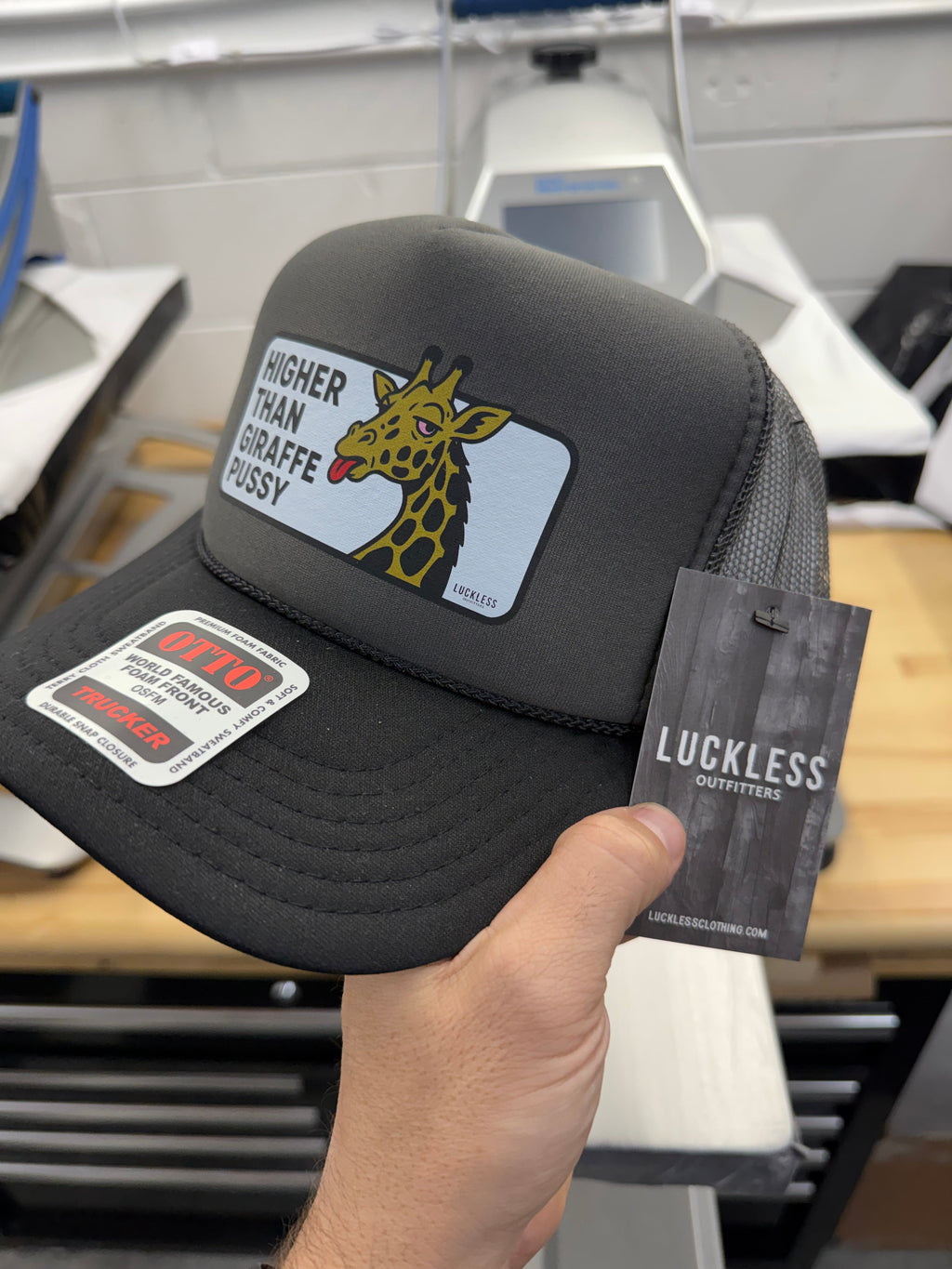 Luckless Outfitters Higher Than Giraffe Pussy Trucker Hat — in-use photo