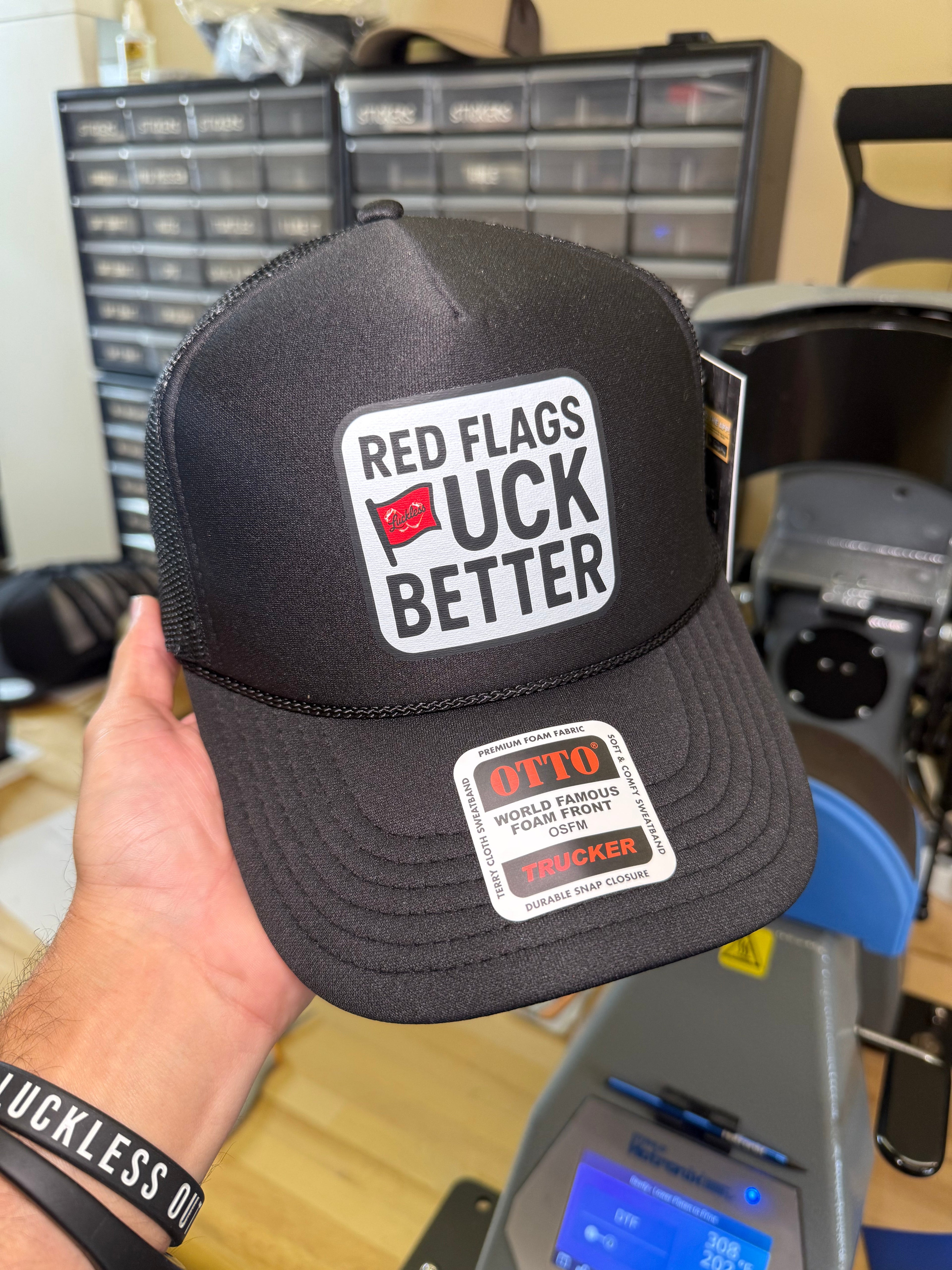 Luckless Outfitters Red Flags Fuck Better Trucker Hat — side view