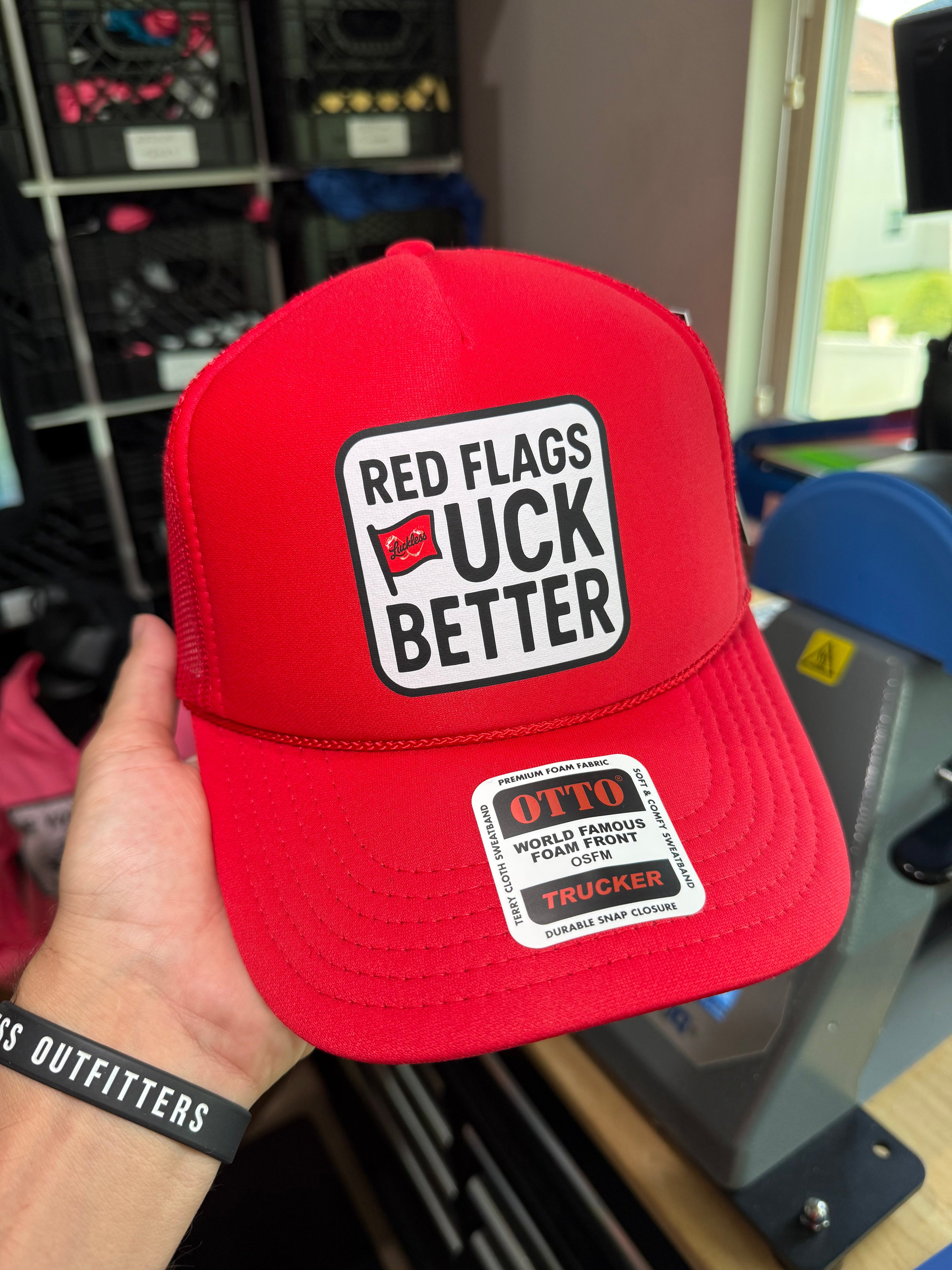 Luckless Outfitters Red Flags Fuck Better Trucker Hat — lifestyle context