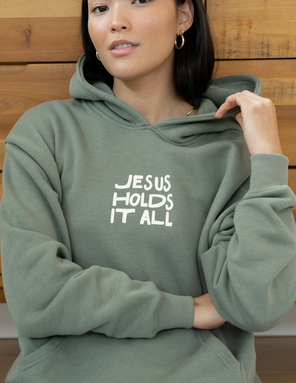 Elevated Faith Jesus Holds It All Unisex Hoodie — lifestyle worn / used context