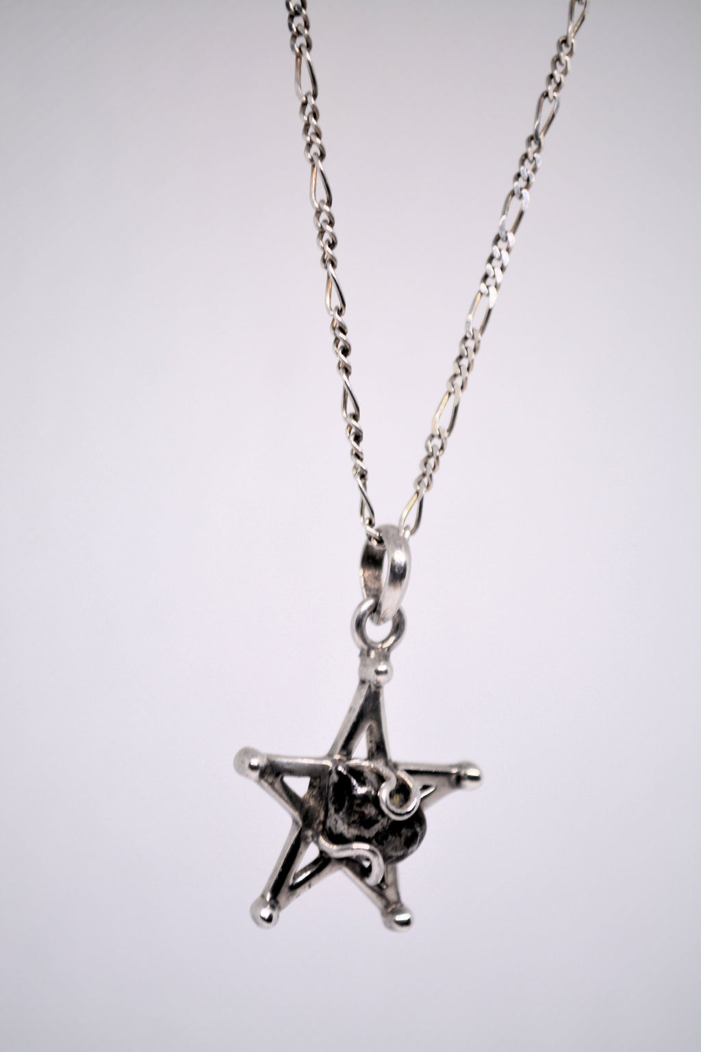 Just Neat Stuff Starborn Campo del Cielo Meteorite Star Pendant in Sterling Silver — Just Neat Stuff branding close-up