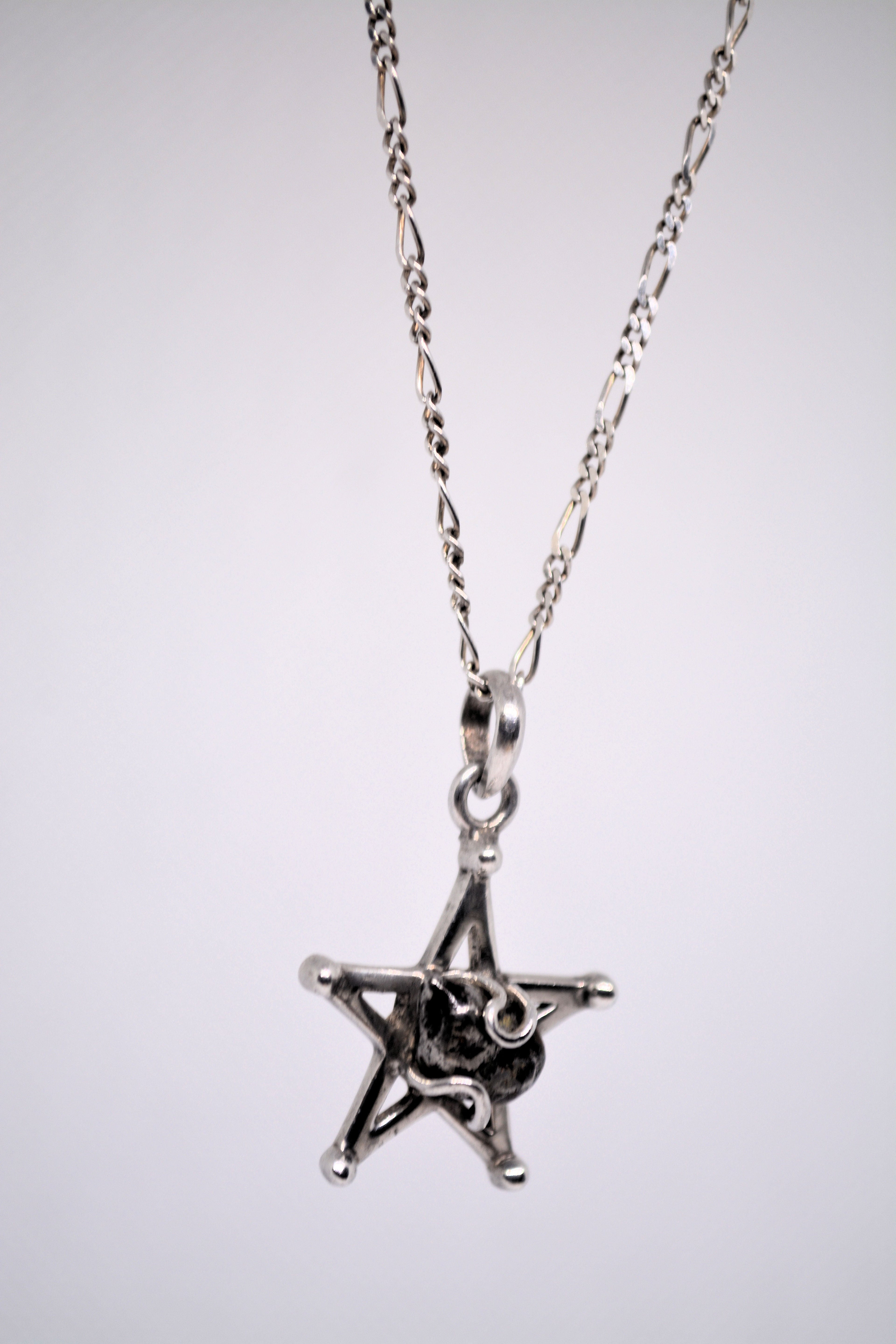 Just Neat Stuff Starborn Campo del Cielo Meteorite Star Pendant in Sterling Silver — Just Neat Stuff branding close-up