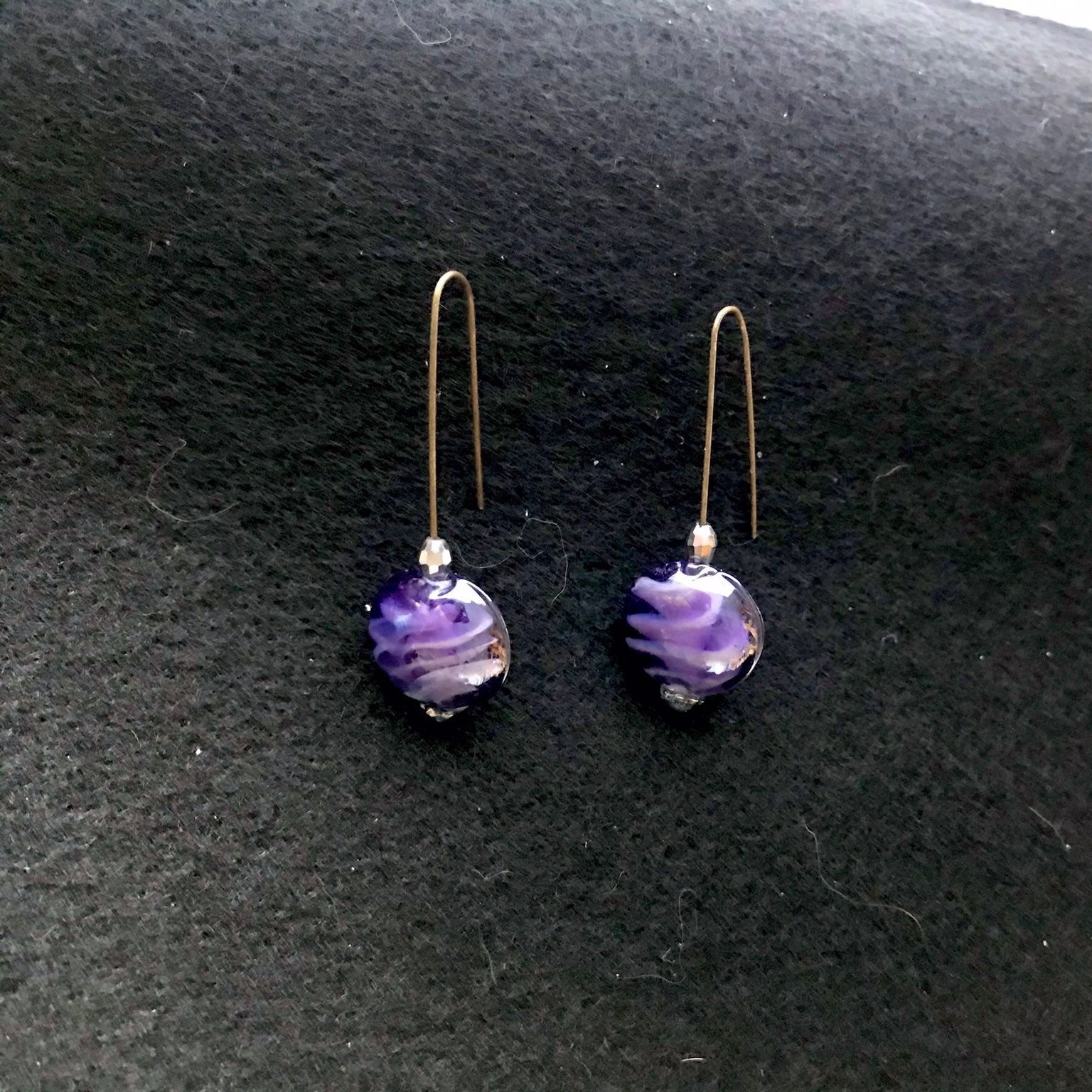 Just Neat Stuff Purple glass earrings — lifestyle context