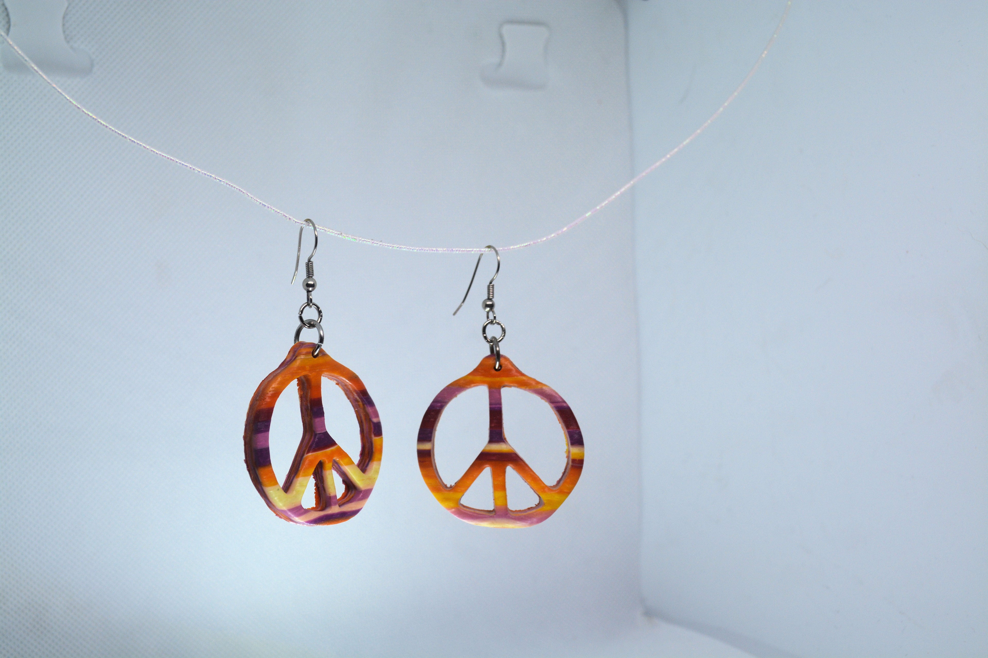 Just Neat Stuff Peace Earrings — side view