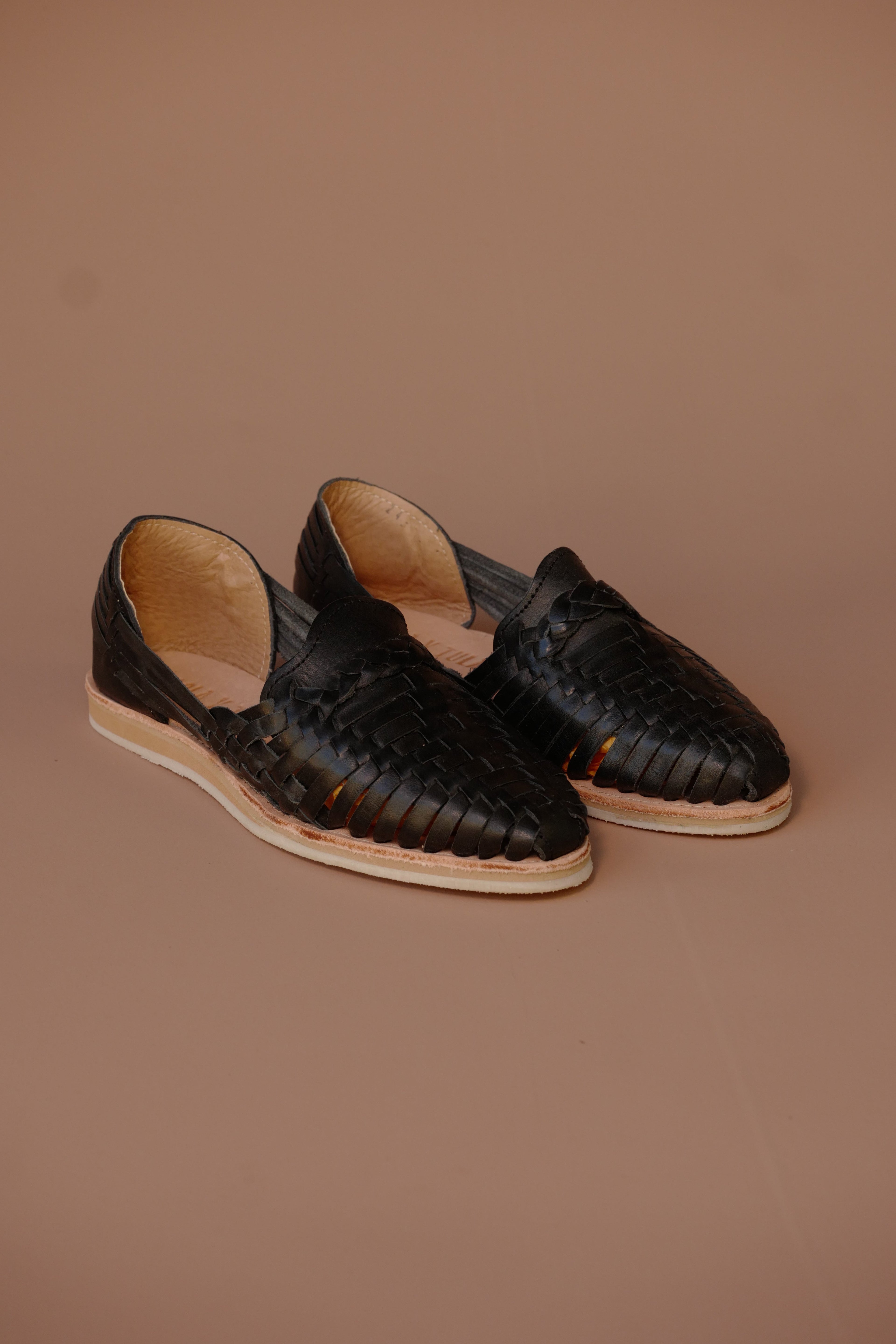 LOLA Y TULA Black Leather Huarache — lifestyle context