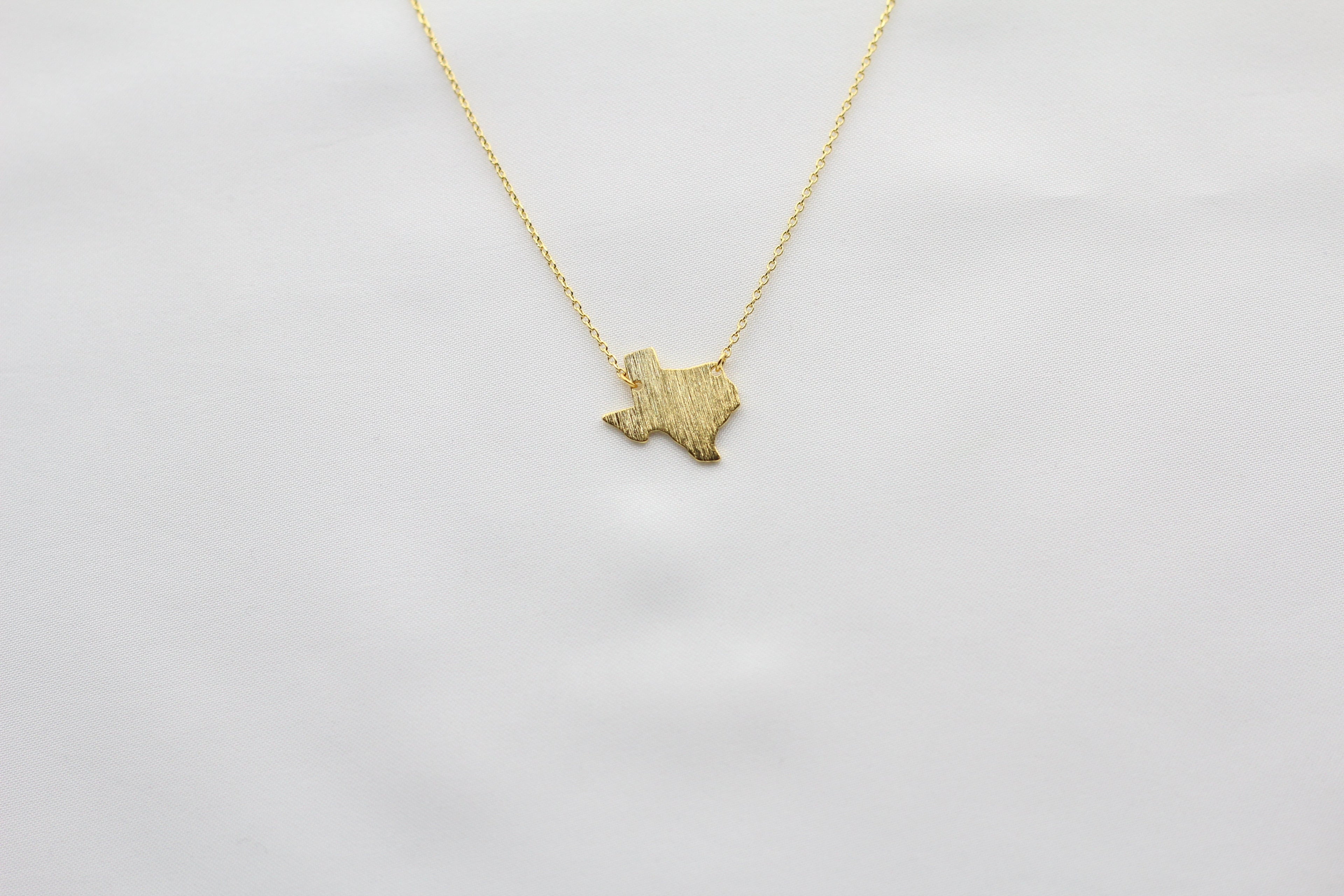 KADOU BOUTIQUE Texas State Map Necklace - Matte Polish — lifestyle context