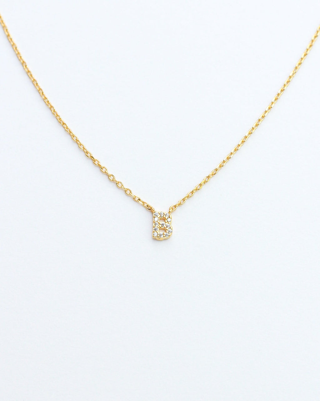 KADOU BOUTIQUE Mini Pave Initial Necklace — lifestyle context