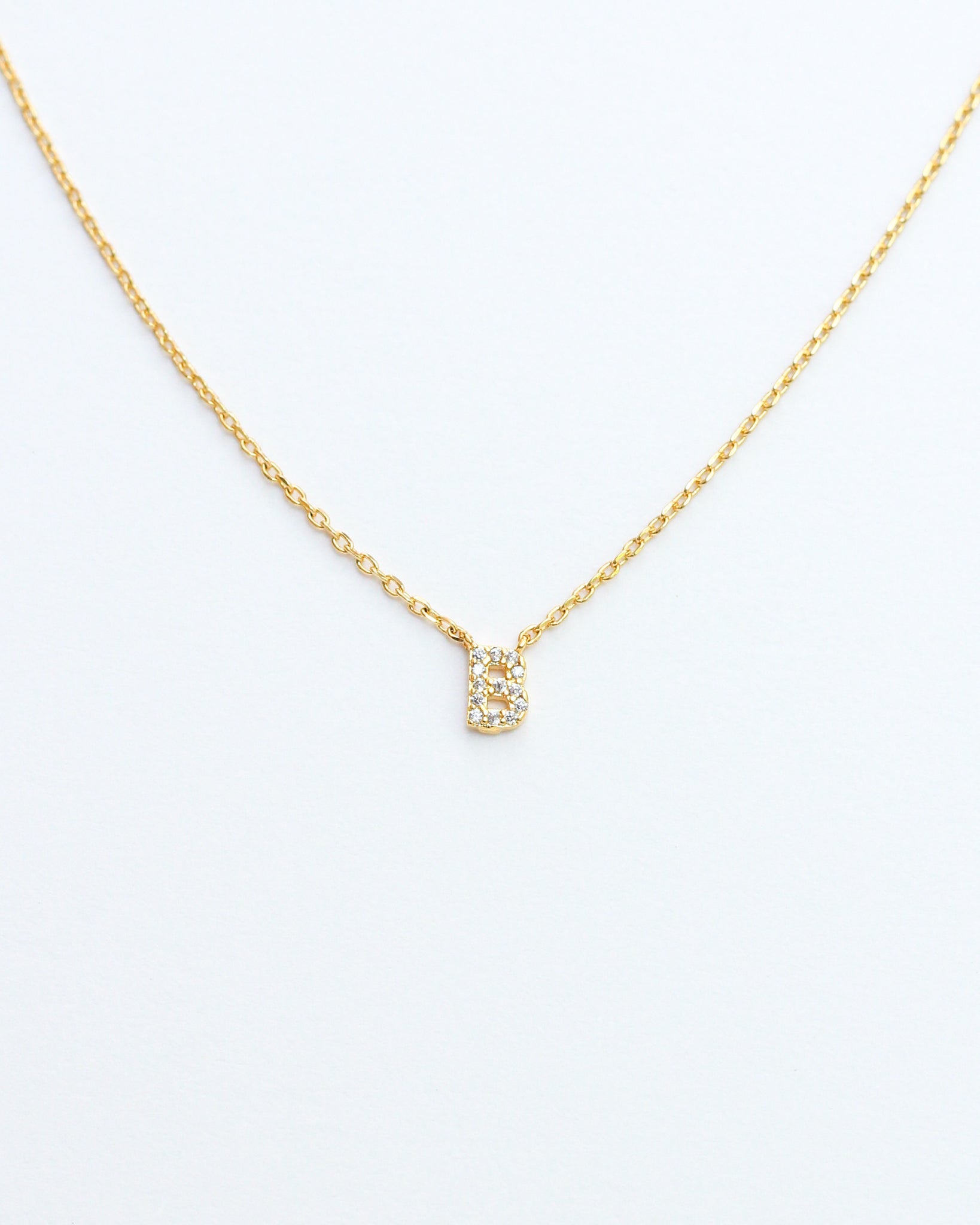 KADOU BOUTIQUE Mini Pave Initial Necklace — lifestyle context