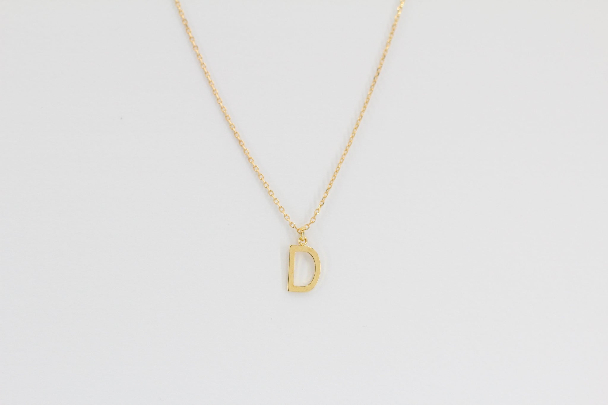 KADOU BOUTIQUE Letter Pendent Necklace — detail close-up