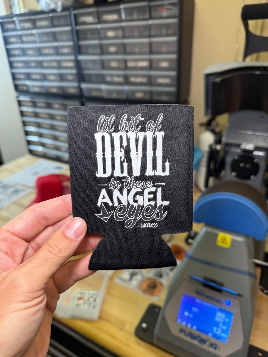 Luckless Outfitters Lil Bit Of Devil in these Angel Eyes Koozie — back view