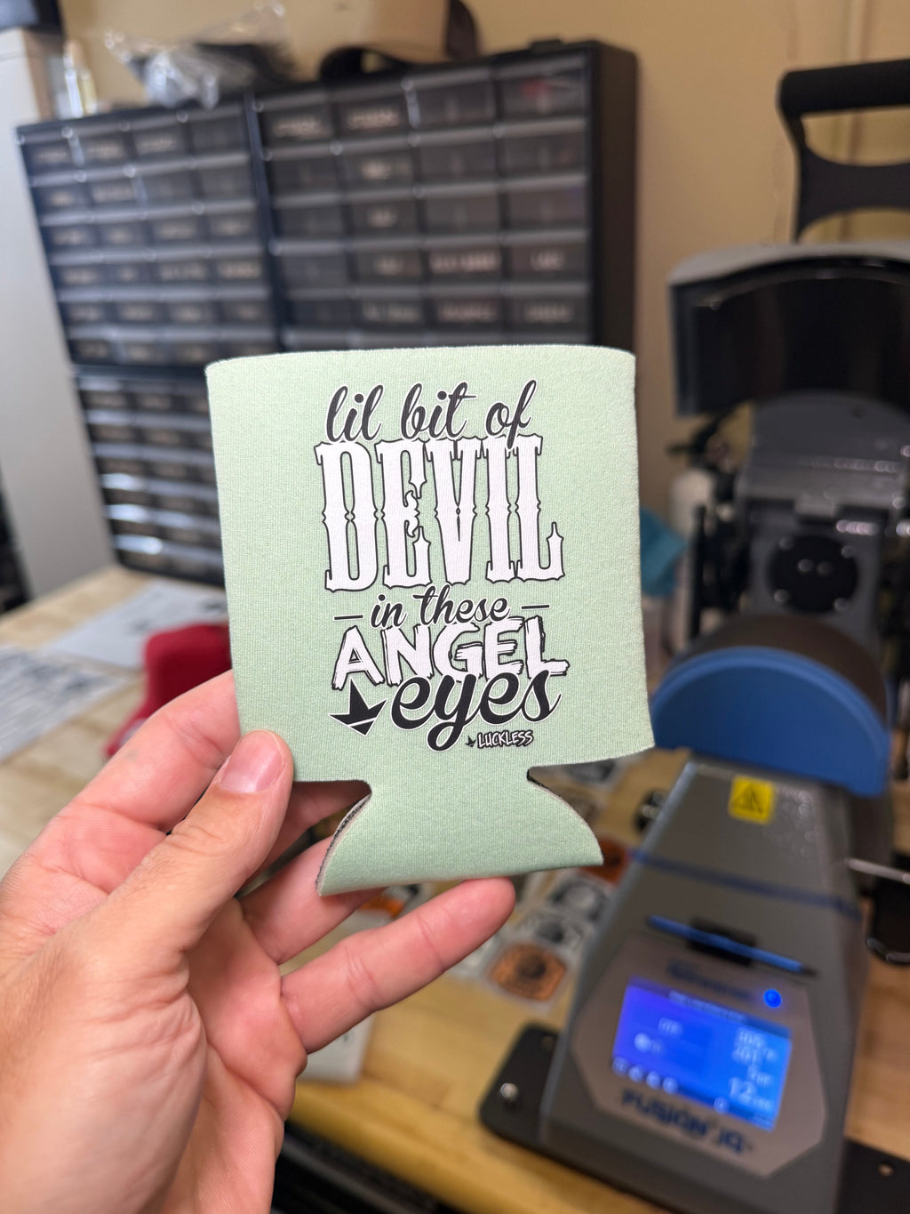 Luckless Outfitters Lil Bit Of Devil in these Angel Eyes Koozie — in-use photo