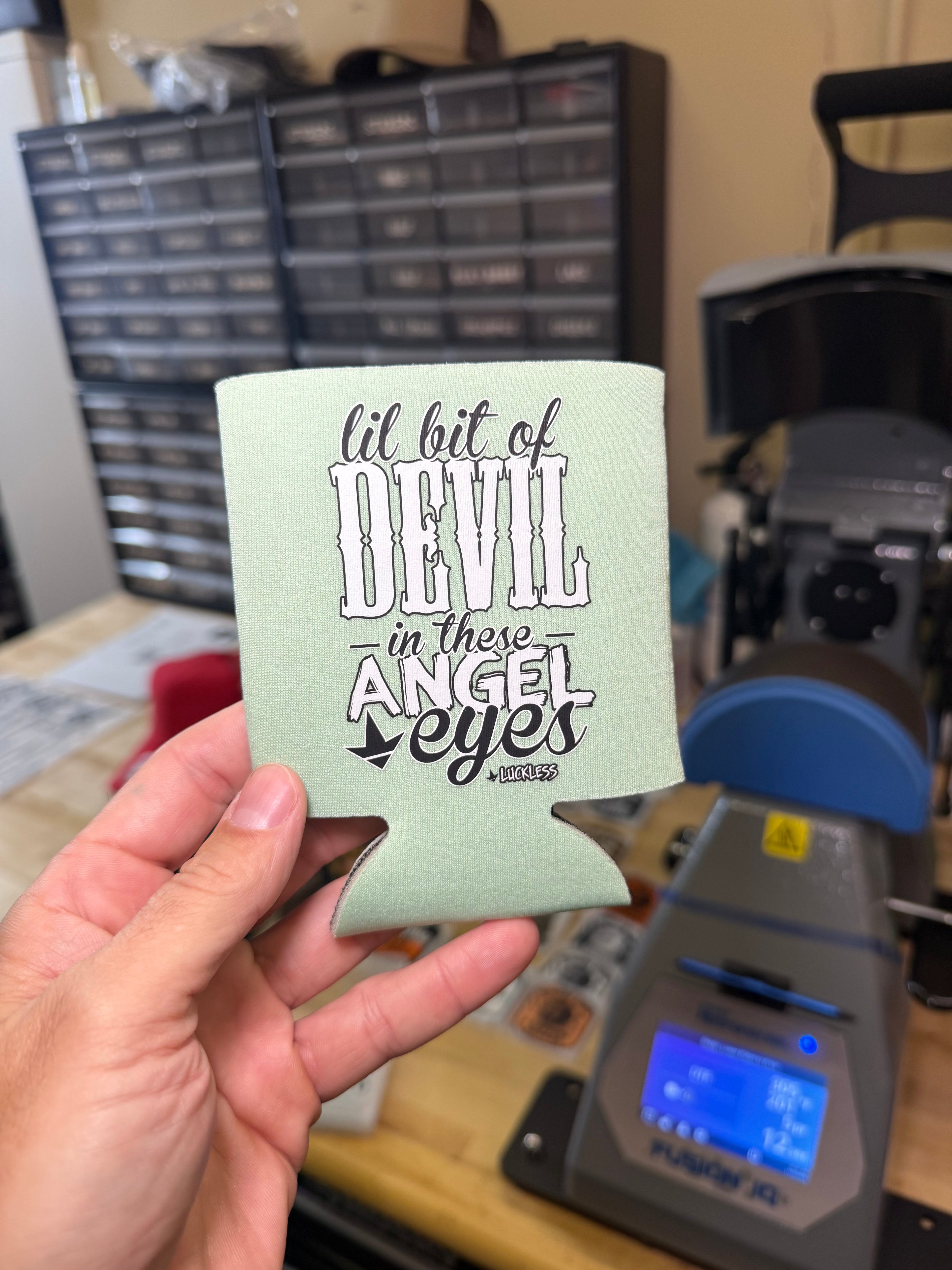 Luckless Outfitters Lil Bit Of Devil in these Angel Eyes Koozie — in-use photo