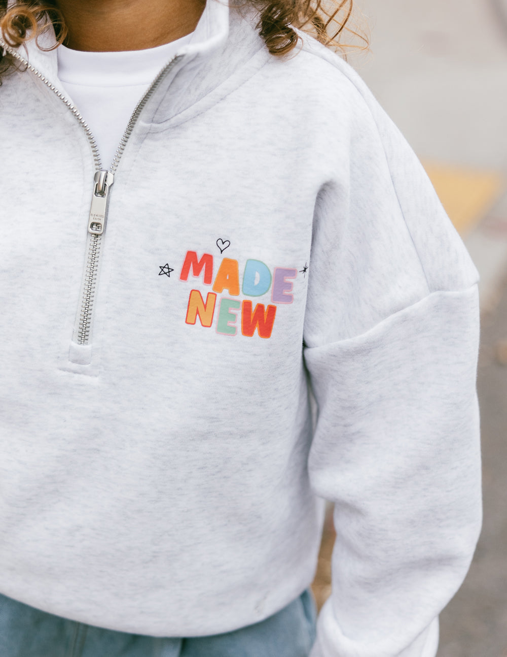 Elevated Faith Made New Kids Half-Zip — Elevated Faith branding close-up