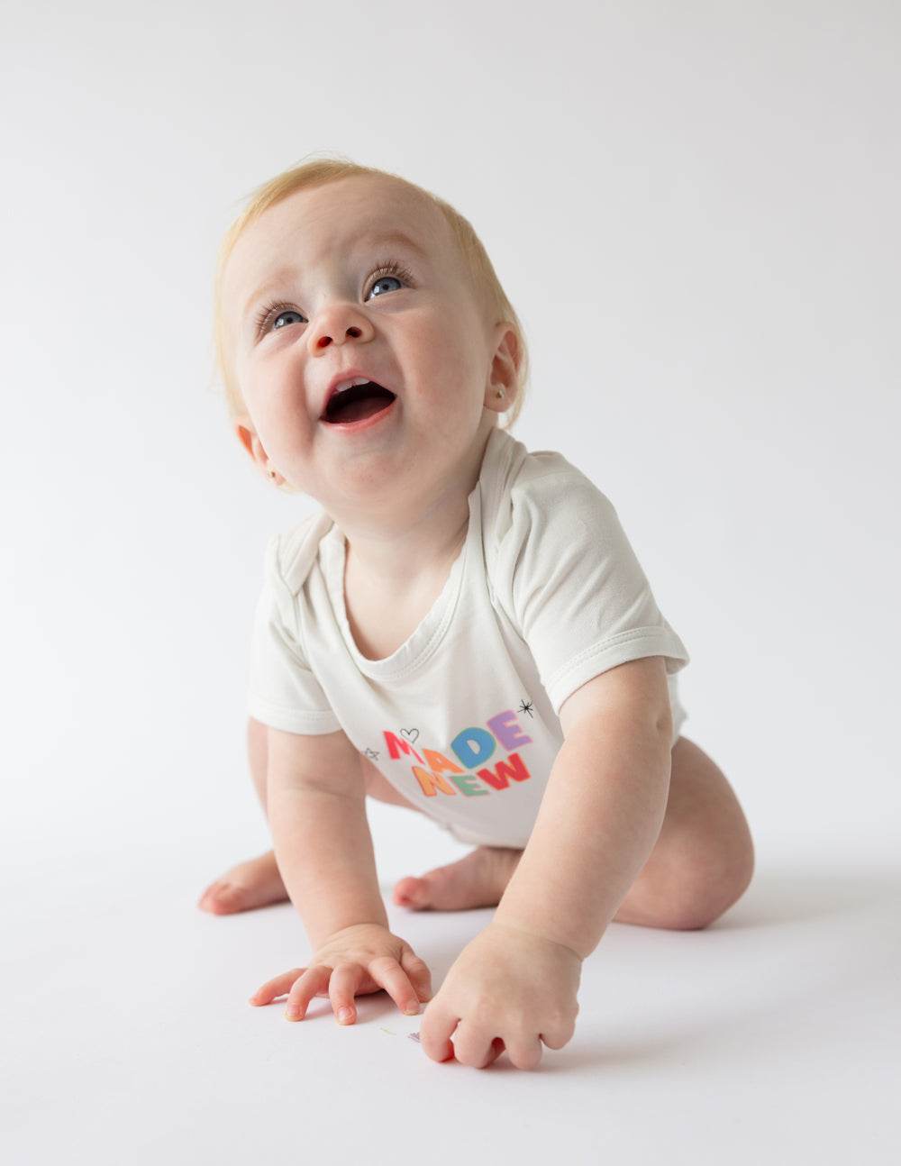 Elevated Faith Made New Onesie — lifestyle context