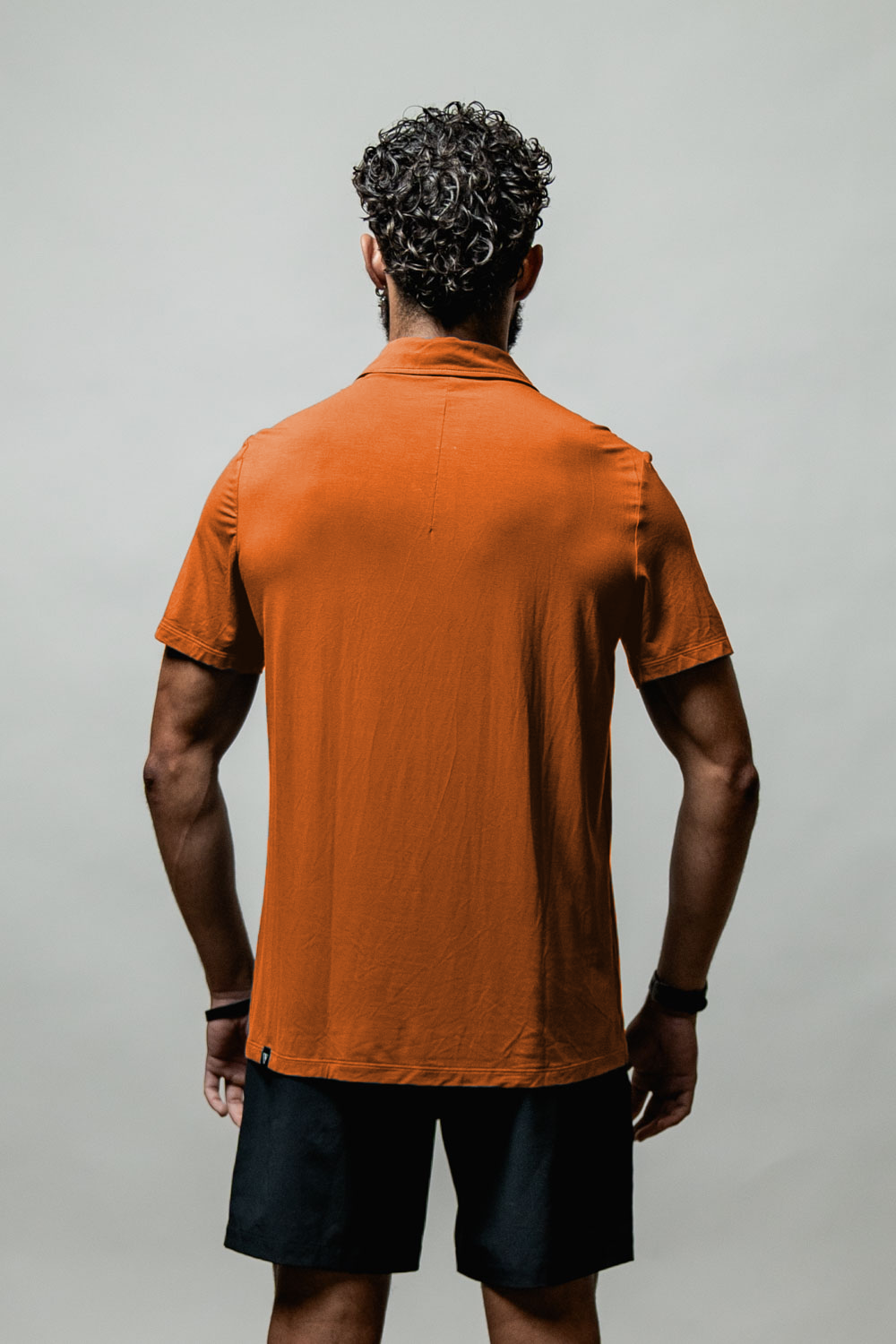 Varlo Men's Terra Recovery Polo (Sunfire Clay) — Varlo branding close-up